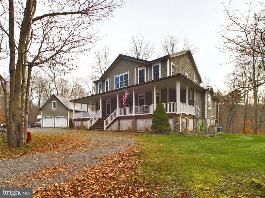 Gorgeous colonial farmhouse on 10 plus River front acres bordering the Lackawana State Forest. 383 feet of frontage on the upper Lehigh River which is rated as exceptional value by DEP. This 4 bedroom, 3 bath home with a 2-car detached garage is nestled on lots of land in the beautiful Poconos. Main level has wide plank natural white oak flooring and boasts a kitchen with granite countertops, gas stove with double oven, and ss appliances. A dining area with sliding doors leading to a large screened in porch with 3 skylights and mahogany decking. The living room has a stone wood burning fireplace. The foyer has 8' tall French doors that open to a covered wrap around porch with mahogany flooring. Primary bedroom has a walk-in-closet and private bath with custom walnut cabinetry, a claw foot tub, and a large, tiled shower. The bedroom also has sliders to another mahogany deck. The upstairs has a large family room, 2 large bedrooms, a full bath, and an additional office/den. Lower level has a workshop & craft room with custom cabinetry, laundry room and storage. Outside features include metal roof, exterior of stone and cedar vinyl shakes, a paved driveway, detached 2 car garage, a wraparound front porch, outdoor shower, and a fire pit. This home has it all! Please use Google maps for street view of home.