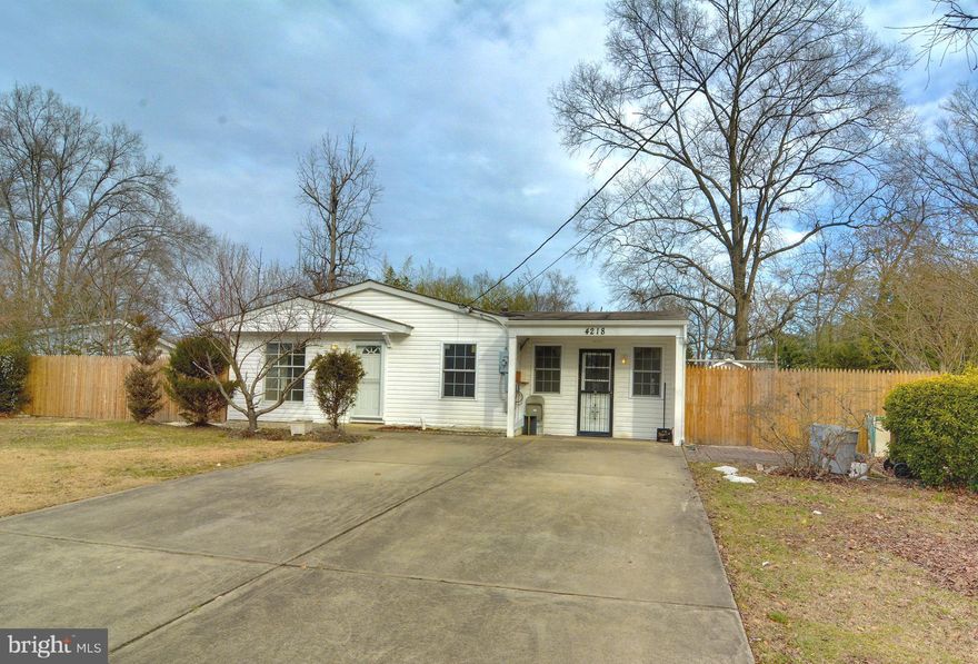 Serene lot with a fully fenced in back yard, raised garden beds, quaint fairy bridge, spacious driveway, and two sheds. Ready to make it your own! New flooring all throughout. Electricity, plumbing, and roof completely replaced in 2009. New HVAC and hot water heater.  NO HOA!