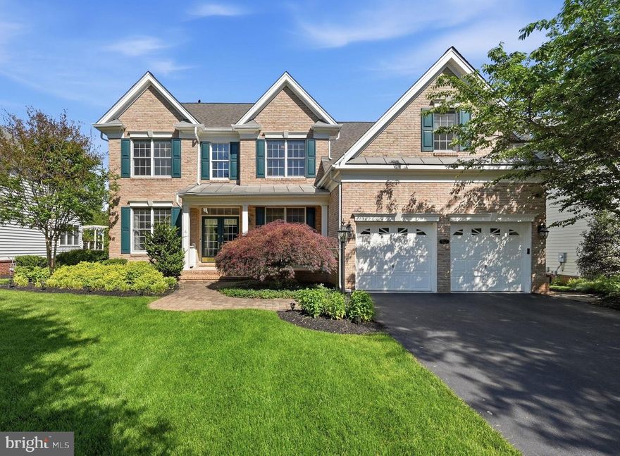 Nestled within the prestigious gated community of Dominion Valley Country Club, this beautifully updated Ellsworth model offers 5 bedrooms, 3 full and 2 half baths, and over 5,000 square feet of finished living space designed for both comfortable everyday living and exceptional entertaining. With its open floor plan, premium fenced backyard, and thoughtfully updated interiors, this home blends timeless elegance with modern convenience in one of Haymarket’s most sought-after communities.

A charming light brick façade, welcoming front porch, and double-door entry create an inviting first impression. Inside, a dramatic two-story foyer welcomes you into bright, expansive living spaces filled with natural light. The spacious kitchen has been beautifully updated with pristine white quartz countertops, a new five-burner gas cooktop, new sink, and new stainless steel KitchenAid appliances. The kitchen flows seamlessly into the grand two-story extended family room, highlighted by a soaring Palladian window and a gas fireplace recently enhanced with a sleek quartz surround. Just beyond, the light-filled sunroom opens to a large Trex deck and fully fenced backyard backing to trees, creating the perfect indoor-outdoor flow for entertaining or relaxing evenings at home. A private main-level office overlooking the backyard offers an ideal work-from-home retreat.

Upstairs, the expansive primary suite features a private sitting area, luxurious bath, walk-in closet, and an additional adjoining flex room ideal for a private office, dressing room, nursery, fitness space, or an additional custom walk-in closet. Three additional generously sized bedrooms and a well-appointed hall bath provide comfortable accommodations for family or guests. The walkout lower level is exceptionally bright and versatile, offering a spacious recreation room with wet bar, guest bedroom, media room space, additional half bath, and abundant storage. The true highlight, however, is the spa/workout room complete with an infrared sauna that conveys, jacuzzi soaking tub, and oversized steam shower with aromatherapy functionality—creating a private escape designed for ultimate relaxation after a long day.

Additional features include a two-car garage with epoxy flooring and an underground lawn sprinkler system servicing the entire property. Thoughtfully maintained and updated, major system improvements include zoned HVAC systems (2016 & 2017),  water heater (2025), and new kitchen appliances (2025).

Life in Dominion Valley Country Club offers a true resort-style lifestyle with access to the Arnold Palmer Signature Golf Course, renovated clubhouse, indoor and outdoor pools, fitness center, tennis and pickleball courts, scenic walking trails, playgrounds, fishing ponds, and vibrant community events. Ideally located near shopping, dining, wineries, breweries, and major commuter routes including I-66, Routes 15, 29, and 50, this exceptional home offers the perfect balance of luxury, comfort, and convenience in the heart of Haymarket.
