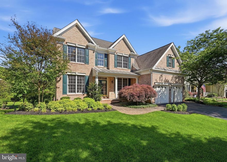 Nestled within the prestigious gated community of Dominion Valley Country Club, this beautifully updated Ellsworth model offers 5 bedrooms, 3 full and 2 half baths, and over 5,000 square feet of finished living space designed for both comfortable everyday living and exceptional entertaining. With its open floor plan, premium fenced backyard, and thoughtfully updated interiors, this home blends timeless elegance with modern convenience in one of Haymarket’s most sought-after communities.

A charming light brick façade, welcoming front porch, and double-door entry create an inviting first impression. Inside, a dramatic two-story foyer welcomes you into bright, expansive living spaces filled with natural light. The spacious kitchen has been beautifully updated with pristine white quartz countertops, a new five-burner gas cooktop, new sink, and new stainless steel KitchenAid appliances. The kitchen flows seamlessly into the grand two-story extended family room, highlighted by a soaring Palladian window and a gas fireplace recently enhanced with a sleek quartz surround. Just beyond, the light-filled sunroom opens to a large Trex deck and fully fenced backyard backing to trees, creating the perfect indoor-outdoor flow for entertaining or relaxing evenings at home. A private main-level office overlooking the backyard offers an ideal work-from-home retreat.

Upstairs, the expansive primary suite features a private sitting area, luxurious bath, walk-in closet, and an additional adjoining flex room ideal for a private office, dressing room, nursery, fitness space, or an additional custom walk-in closet. Three additional generously sized bedrooms and a well-appointed hall bath provide comfortable accommodations for family or guests. The walkout lower level is exceptionally bright and versatile, offering a spacious recreation room with wet bar, guest bedroom, media room space, additional half bath, and abundant storage. The true highlight, however, is the spa/workout room complete with an infrared sauna that conveys, jacuzzi soaking tub, and oversized steam shower with aromatherapy functionality—creating a private escape designed for ultimate relaxation after a long day.

Additional features include a two-car garage with epoxy flooring and an underground lawn sprinkler system servicing the entire property. Thoughtfully maintained and updated, major system improvements include zoned HVAC systems (2016 & 2017),  water heater (2025), and new kitchen appliances (2025).

Life in Dominion Valley Country Club offers a true resort-style lifestyle with access to the Arnold Palmer Signature Golf Course, renovated clubhouse, indoor and outdoor pools, fitness center, tennis and pickleball courts, scenic walking trails, playgrounds, fishing ponds, and vibrant community events. Ideally located near shopping, dining, wineries, breweries, and major commuter routes including I-66, Routes 15, 29, and 50, this exceptional home offers the perfect balance of luxury, comfort, and convenience in the heart of Haymarket.