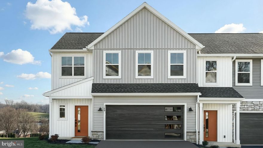 This 2-story, end-of-row townhome includes a first-floor owner’s suite, a 2-car garage, and durable vinyl plank flooring. The family room, with an ample amount of natural light opens to the rear deck offering stunning views. The kitchen is well-appointed with stainless steel appliances, quartz countertops, and a large center island that opens to the dining area. The owner’s suite, tucked quietly to the back of the home, features an expansive closet and a private bathroom. On the 2nd floor, there are two additional bedrooms and a full bathroom.