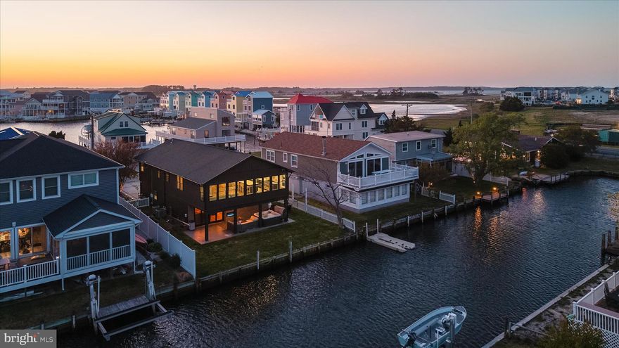 Welcome to 39123 Van Buren Avenue in the desirable community of Edgewater Acres, where refined coastal living meets effortless waterfront enjoyment. Completely remodeled down to the studs in 2022, this canal-front retreat offers a seamless blend of modern design, comfort, and style, all just about a mile from the beach. No Hoa! This amazing  home is ready for immediate enjoyment. 

Curb appeal abounds with striking vertical siding, thoughtfully designed exterior lighting, and a spacious concrete driveway accented by a paver border, offering ample parking for up to six vehicles. A welcoming set of double doors opens to a functional foyer featuring a custom built-in, creating the perfect drop zone for beach gear after a day on the water.

Ascend the turned staircase, highlighted by a sleek cable railing system, to the main living level where an open and airy floor plan unfolds. The heart of the home is a stunning gourmet kitchen designed to impress, featuring a seven-burner ZLINE range with dual ovens, stainless range hood, pot filler, quartz countertops, and a designer tile backsplash. Soft-close cabinetry includes contrasting navy lower cabinets and white upper cabinets with trim detail, along with pantry storage and an expansive island offering additional seating and storage.

The kitchen flows effortlessly into the dining and living areas, where luxury vinyl plank flooring runs throughout and a dramatic vaulted ceiling enhances the sense of space. A wall of windows captures serene canal views, filling the home with natural light and creating a picturesque backdrop for everyday living. An eight-blade ceiling fan adds both style and comfort to the main gathering space.

The primary suite is a true retreat, complete with a walk-in closet and a beautifully appointed en suite bath featuring a dual vessel sink vanity, LED mirrors, a freestanding soaking tub, and a frameless glass shower with bench seating, rain head, and handheld fixture, all elevated by luxurious heated designer tile flooring. Two additional bedrooms and a full hall bath complete the main level.  

The lower level is designed for entertaining and relaxation, offering a spacious family room with an adjacent wet bar equipped with an additional refrigerator, dishwasher, and standalone ice maker. A fourth bedroom, full bath, and a laundry center with ThinQ front-loading washer and dryer appliances. 

Step outside through transom sliding glass doors to a private outdoor oasis, complete with a covered patio featuring a linear electric fireplace, mounted TV, and hot tub. The generous yard space invites gatherings, while the canal-front setting offers easy access to the water and a tranquil coastal ambiance.  Behind the garage door is plenty of storage space for bikes, water toys, and seasonal items.  

Ideally located near local favorites such as Catch 54 and Harpoon Hanna's, perfect for boating enthusiasts, this home is also just moments from the peaceful shores of Fenwick Island Beach. Offering the perfect combination of luxury, location, and lifestyle, this exceptional waterfront property delivers an unforgettable coastal living experience.