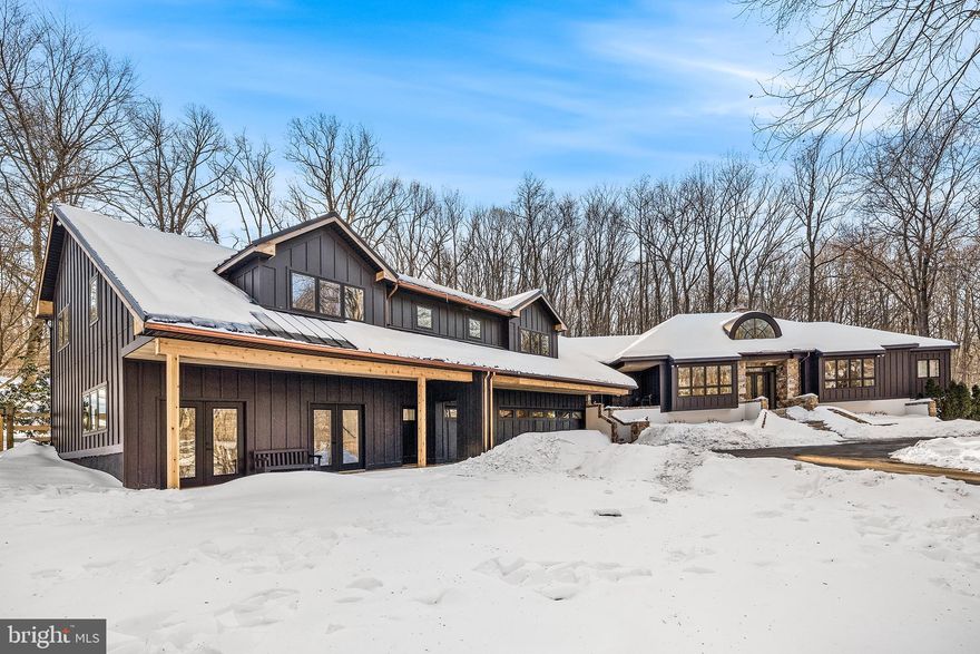 Tucked away at the end of a long, private driveway, this exceptional custom home sits on 8.5 picturesque acres overlooking Birchrun Creek in the heart of Chester Springs. Surrounded by scenic woodlands and neighboring premier horse farms, the property offers remarkable privacy while remaining just minutes from Route 100 and the Pennsylvania Turnpike.

A circular driveway and striking new James Hardie board-and-batten siding with stone accents create an impressive arrival. Custom double doors open to a dramatic octagonal Great Room, where soaring cathedral ceilings, a fireplace, brand new 72 inch ceiling fan, custom built-ins, and a full wall of windows showcase breathtaking natural views and fill the home with light.

Just off the Great Room, the primary suite serves as a true retreat, featuring a fully renovated spa-like bath with heated floors, quartz countertops, a cast iron clawfoot tub, a spacious windowed walk-in shower, and a custom dressing area with walk-in and cedar closet. The main level is thoughtfully designed for both everyday living and entertaining, offering an updated kitchen with quartz countertops, hardwood floors, walk-in pantry, and breakfast area wrapped in windows with access to a hardscape patio. Additional spaces include a formal dining room filled with natural light, a powder room, and an oversized laundry room with its own exterior entrance.

The home’s guest wing provides exceptional flexibility and privacy, featuring a bedroom, full bath, sitting area, and generous storage. This area connects seamlessly to a substantial addition that expanded the home by approximately 700 square feet of first-floor living space with 10-foot ceilings. The addition includes a fully insulated gym or multipurpose room, kitchenette with semi-custom cabinetry and quartz countertops, new GE appliances, an additional laundry room, full bath with seamless walk-in shower, a bedroom with custom walk-in closet, multiple French doors, and a private exterior entrance. The second level of the addition features hardwood floors matched to the original home.

The lower level further enhances the living space with a finished basement offering a remodeled full bath, mirrored wet bar, exercise or lounge area, a bright bedroom, and an unfinished section with windows and outside access. A heated three-car attached garage provides interior access along with a separate exterior entrance.

In total, the property offers approximately 7,500 square feet of living space with four bedrooms, an office, a den, two lounge areas, two laundry rooms, four full baths, and one half bath.

This is a rare opportunity to own a private, meticulously upgraded estate in one of Chester County’s most desirable locations.