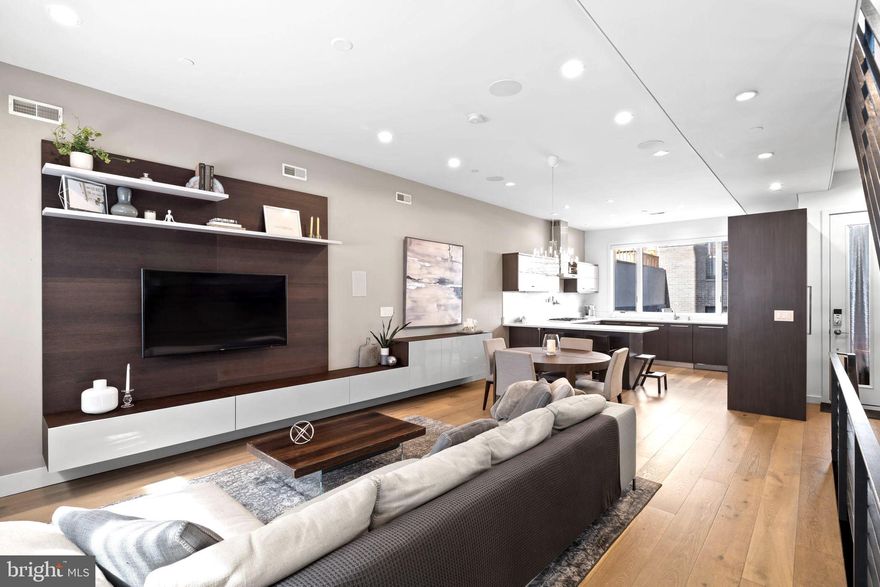 Introducing 204 W Laurel Street, a luxury residence in the exclusive Laurel Court community in Northern Liberties—just steps from Liberties Lands Park, The Piazza, and top dining, markets, and nightlife. This three-story townhome offers nearly 3,000 Sq Ft, with 3 bedrooms, 3 full baths, 1 half bath, private parking, and multiple outdoor spaces, including a rear patio with gas line, primary suite terrace, and a large roof deck with gas line and skyline views. Inside, the home features custom European-style wood veneer cabinetry, Silestone quartz countertops, porcelanosa kitchen and bath design, and a custom tile backsplash. Additionally - a full suite of panel-ready Thermador appliances, including a 36” gas cooktop, integrated refrigerator and dishwasher, convection oven and microwave, and pot filler. Main living areas boast 3/4” hardwood floors, oversized Andersen 400 windows, a gas fireplace, motorized shade wiring, and 5.1 surround sound prewiring. The open-riser staircase is a design focal point, built with solid wood treads, steel stringer, and custom metal railings. The primary suite includes a large walk-in closet system, floor-to-ceiling windows, and a spa-like bath with freestanding soaking tub, 6’x4’ rain shower with body sprays and hand shower, custom floating double vanity, and wall-mounted European toilet. The finished basement includes heated porcelain tile floors, a full bath, and a large storage/flex space ideal for a gym or guest suite. A pilothouse wet bar with sink and wine fridge offers convenient access to the roof deck. Additional highlights: Dual-zone high-efficiency HVAC, 200 Amp electric, CAT6 wiring + video intercom system, Prewired for full home automation, TREX composite decking, 20-year certified TPO roof, NuHeat radiant heating in basement floors, 10’ ceilings on living and primary levels. A rare blend of thoughtful architecture, custom finishes, and prime location. 204 W Laurel Street delivers high-end living in one of Philadelphia’s most coveted neighborhoods.