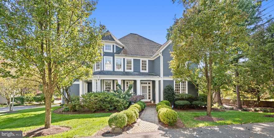 Ideally located on a quiet cul-de-sac off Democracy LANE, this custom-built Nantucket-style home is truly one-of-a-kind.  Located in the Courts of Democracy, a development of just 12 delightful residences, not in an HOA.  The dramatic, welcoming two-story foyer sets the tone for the elegance found throughout this turn-key home. The main level boasts a light-filled living room, formal dining room, chef’s eat-in kitchen, and a spacious family room with dramatic ceiling height, native stone gas fireplace and double doors to the sun-filled deck.  The gourmet kitchen features stainless steel appliances including a SubZero refrigerator, island with countertop seating, custom cabinetry and plantation shutters. Charm and sophistication abound; flooded with natural light, gleaming hardwood floors, recessed lighting, and incredible ceiling height throughout the home.
 
The natural light-filled upper level features a luxurious primary retreat with a sitting room, two walk-in closets, vaulted ceilings, and a recently renovated spacious spa-like ensuite bathroom. Three more nicely sized additional bedrooms and two full bathrooms, one ensuite, round out the upper level.
 
The lower level offers even more living space with an additional bedroom, full bathroom, office space, recreation room with a wood burning fireplace, generous laundry room as well as a storage room. The attached two-car garage has additional storage space along with an electric vehicle charger. Additional guest parking for four cars. Enjoy this tranquil setting on the wraparound porch or the rear deck, open to the professionally landscaped yard, private and low maintenance with an inground sprinkler system. 
 
Conveniently located near Cabin John Mall, Cabin John Park & Ice-Skating Rink, Montgomery Mall, and an abundance of swim, tennis, and recreational parks, giving residents easy access to a variety of amenities. Bells Mill ES, Cabin John MS, and blue-ribbon Churchill High School serve the neighborhood. This property offers a perfect combination of elegance, functionality, and convenience, making it a truly turn-key home. Welcome home! 
 
* Please note: this property is on Democracy Lane, not Boulevard. *