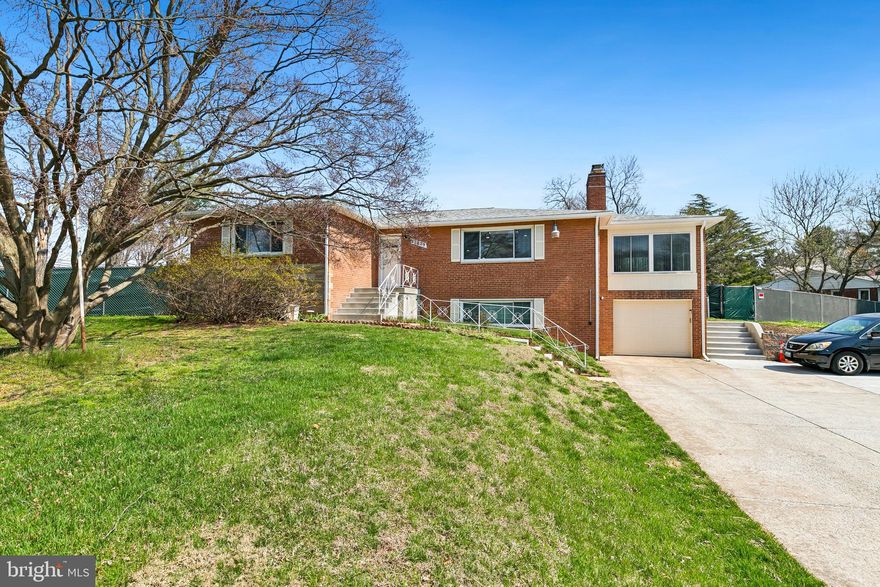 Welcome to this beautifully updated and incredibly versatile home with 7 bedrooms and 5 full baths, offering approximately 3,300 square feet, including 1,832 square feet above grade, along with over $175,000 in improvements throughout. From the moment you arrive, the significantly expanded driveway, with parking for 10 to 15 cars, makes a striking first impression and offers exceptional convenience rarely found at this price point. Inside, the home has been freshly enhanced with refinished hardwood floors, fresh paint throughout, and updated lighting, creating a bright, polished feel across the main level. The foyer welcomes you with hardwood flooring and a coat closet, leading into a warm and inviting layout designed for both everyday living and flexible use. The kitchen features new recessed lighting, a new stove, and a new refrigerator, while the side addition has been fully painted and updated with new luxury vinyl plank flooring, offering additional living space with direct access to the backyard. The rear outdoor space is fully fenced with added privacy screening, creating a private setting for relaxing, entertaining, or enjoying the outdoors. A brick storage building with electricity adds valuable bonus space for hobbies, storage, or workshop needs. The main level bedrooms feature hardwood flooring, and the home’s bathrooms have been extensively renovated with elegant finishes. The hall bath has been completely redone with marble walls and flooring, a new tub/shower, a new vanity, and a linen closet. The primary suite includes hardwood flooring, mirrored bifold closet doors, and a stunning fully renovated en-suite bath featuring marble tile walls and floors, a barn-style shower door, and designer ceramic tile accents. The lower level offers remarkable additional living space and flexibility, complete with a second kitchen area featuring granite counters, refrigerator, built-in microwave, electric range, and a charming stone/brick fireplace with wood mantel. With multiple legal bedrooms, two fully renovated full bathrooms with marble tile floors and walls, updated flooring, new panels, recessed lighting in select rooms, and its own exterior access, the lower level opens up a variety of possibilities for extended living, guest space, or multi-generational use. Additional updates include new vents, new outlets, attached microwave installation, a roof approximately 2–3 years old, and a fully fenced rear yard designed for privacy and functionality. This is a rare opportunity to own a substantially improved home with tremendous space, extensive updates, exceptional parking, and a flexible floor plan to fit a wide range of needs. The property is located in Meadowood, a well-established Silver Spring community known for its spacious homes, mature setting, and no HOA, offering a relaxed residential feel with everyday convenience. The location also provides easy access to shopping and dining along the New Hampshire Avenue corridor, nearby transit options including Montgomery County Ride On service, and the broader amenities of Silver Spring, making it a great fit for buyers who want both neighborhood charm and commuter convenience. ***MORTGAGE SAVINGS MAY BE AVAILABLE FOR BUYERS OF THIS LISTING.***