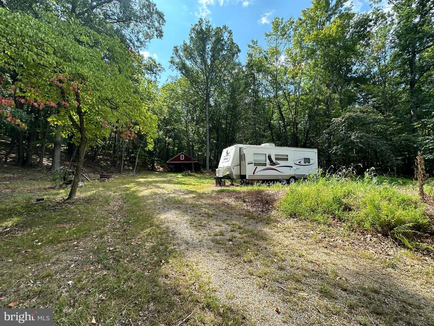 MOUNTAINEER STARTER KIT......10 GORGEOUS 100% USABLE WOODED ACRES.....IT'S LIKE HAVING YOUR OWN PRIVATE PARK; TOWERING WHITE OAKS, FERN COVERED FOREST FLOOR AND BOLD WET WEATHER STREAM. COMES WITH CLEAN 2005 JAYCO CAMPER, 2004 ARCTIC CAT ATV AND POLE BARN PROVIDES DRY PARKING & STORAGE ABOVE. UNDERGROUND ELECTRIC & FIBER INTERNET AT STREET, APPROVED PERK! WHEN YOU FACTOR IN THE CAMPER, ATV, POLE BARN & DRIVEWAY.....YOU'RE GETTING ABOUT 25K IN GOODIES......YOU CAN ENJOY THIS PROPERTY ON DAY ONE! CAMP, HUNT OR BUILD YOUR WEEKEND RETREAT OR FULL TIME SPREAD. MEADOW HILLS IS A WELL MAINTAINED ESTABLISHED COMMUNITY COMPRISED OF WEEKEND WARRIORS AND FULL TIMERS.....ONLY 5 MILES OFF CORRIDOR H AND 2 HOURS FROM DC. YOU COULD LOOK FOR A LONG TIME BEFORE YOU FIND A PRETTIER PIECE OF WOODS. WHY PAY WELL OVER 100K FOR 20 ACRES, WITH ONLY A FEW ACRES OF USABLE LAND? HERE'S 10 ACRES THAT YOU CAN USE EVERY SQUARE INCH OF, YOU'RE GETTING 25K WORTH OF IMPROVEMENTS AND IT'S READY FOR IMMEDIATE USE. ONCE YOU LAY EYES ON THIS PROPERTY, THE DECISION WILL BE EASY.....BRING YOUR CHECK BOOK!