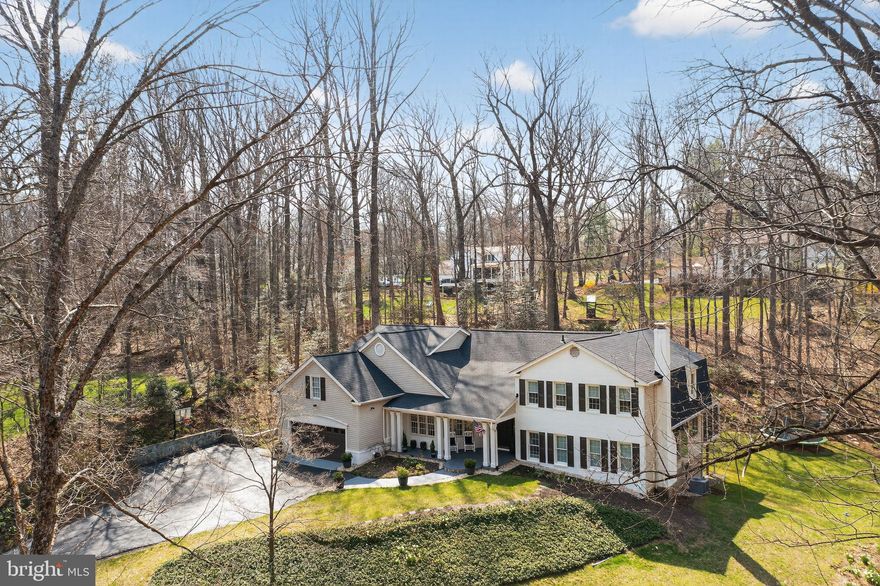 Nestled on a sprawling 3.36-acre property, this meticulously maintained 5-bedroom and 3.5-bath home offers a perfect blend of modern comfort and serene natural surroundings. From its maintenance-free exterior featuring siding and window frames to the thoughtful interior enhancements, every detail has been carefully considered to create a harmonious living space. Additionally, the property boasts a third full garage bay designed as a convenient pull-through, ensuring ample space for a third vehicle without compromising the aesthetic appeal from the front of the house. Step inside to discover a wealth of features designed to enhance both daily living and entertaining. Hardwood floors create a seamless flow throughout the main living areas including the kitchen, living room, dining room, and four bedrooms. High-speed Ethernet/Cat5 cabling ensures connectivity is never an issue, with multiple lines extending to the office and guest suite, making remote work or entertainment a breeze. The heart of the home lies in the family room, where an antique fireplace surround and Vermont Castings wood stove exude warmth and character. Bay windows offer enchanting views of the surrounding forest and creek, inviting you to unwind and relax in the comfort of your own space. For those with creative inclinations, a spacious craft room beckons with its large windows overlooking the woods, providing ample natural light for artistic pursuits. Meanwhile, the first-floor office is primed for productivity, boasting extra electrical circuits and Ethernet/Cat5 lines for seamless internet access. Entertaining is effortless in the living and dining rooms, where custom built-ins, French doors, and expansive views of the natural landscape set the scene for memorable gatherings. Upstairs, the bedrooms offer not only walk-in closets but also breathtaking vistas of the woods and stream valley, providing a tranquil retreat at the end of the day. The primary suite is a sanctuary unto itself, featuring a sitting room, multiple closets including a large walk-in, and a fully renovated bathroom completed in 2024. Guests will feel right at home in their private suite, complete with a separate entrance, full bathroom, and a large finished bonus room over the garage. Practicality meets convenience in the mudroom/laundry room, where built-in cabinetry and custom cubbies streamline organization. Downstairs, the finished basement offers versatile spaces for recreation and storage, with custom built-ins and enhanced electrical wiring for workshop tools. Outside, the property is a nature lover's paradise, boasting acres of pristine woodland, terraced backyard, stone walls, direct access to Little Difficult Run Creek, and backing to Fred Crabtree Park. Whether you're lounging on the screened-in porch, exploring the walking path along the creek, or simply enjoying the views from the decks and patios, this home offers a rare opportunity to embrace the beauty of nature without sacrificing modern amenities.