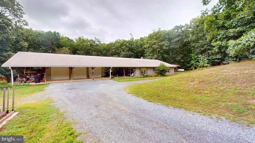 Not your typical 3 bedroom, 2 bath home.  This unique home could be just what you're looking for!  All under one roof provides out of the weather access from the 36'X36' 3 car garage through the 24'X48' breezeway into the 52'X48' open floor plan spacious home.  The home consist of 6 acres,  2 1000 gal septic tanks, all handicap 36" doors 9' ceilings, an artisan well, wet water stream and a barbecue pit out back.  If there is company you like but not well enough to have them stay in your home there is a 30 amp camper hookup including septic and water.  This place has it ALL!