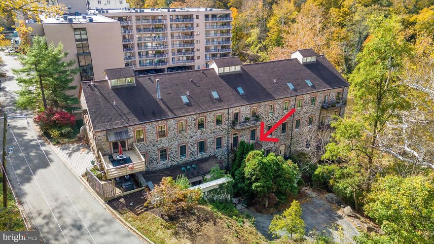 Imagine residing at The Old Mill at Brandywine Park Condominiums — a gated community nestled along the scenic Brandywine River where you can walk through the park, stroll to Josephine Gardens, dine in nearby Trolley Square, or simply relax on your private terrace and enjoy the tranquil views of the water.  This is a truly special opportunity. Once part of a historic 19th-century mill, this distinctive building has been reimagined into this luxe living space. Welcome to Unit 6, an exceptional two-bedroom + den, two-bath designed for modern living, set on the second floor with views of the Brandywine. Step inside to discover stunning entry foyer to greet guests, tall ceilings, hardwood floors, and an open concept layout that seamlessly connects the living, dining, and kitchen spaces. A terrace off the living room provides the perfect spot for morning coffee or tranquil reflection while taking in the sounds and sights of the river. The great room features a cozy fireplace and flows effortlessly to the dining area and full-service kitchen, creating an ideal setting for both everyday living and entertaining. The kitchen is well-appointed with abundant cabinetry, generous counter space, a center island, and a raised breakfast bar for informal dining. The primary suite serves as a peaceful retreat with a spacious bedroom chamber, two walk-in closets, and luxurious bath complete with dual vanities, a large glass-enclosed shower, and a whirlpool soaking tub. The second bedroom is generous in size with its own full bath and ample closet space, while the den offers flexible use as a home office, library, or guest space. Recent upgrades include a high-efficiency heat pump and water heater. The home includes two reserved parking spaces and full access to Brandywine Park’s amenities; front desk security, fitness center, pool, community room, water, sewer, trash removal and common area maintenance – you can rest easy knowing things are cared for!  Unit 6 at The Old Mill combines historic character, modern comfort, and serene beauty, a rare and inspiring place to call home along the Brandywine.
