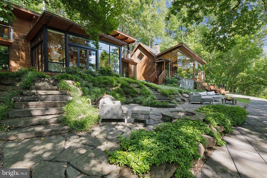 NEW PRICE 11/1!
Dream Retreat on the Potomac River! Nestled on 4 acres of serene woodland, this spectacular retreat offers unparalleled, year round views of the Potomac River. The current home seamlessly blends rustic charm with modern sophistication, featuring expansive 14 foot, floor-to-ceiling windows that flood the interior with natural light and frame the stunning landscape. Enjoy breathtaking vistas from every room, with a spacious patio perfect for entertaining or simply soaking in the tranquility. Engage in a match on your private, full-sized tennis court, beautifully integrated into the natural surroundings. The property also includes a charming chicken coop and a goat run, allowing you to embrace a sustainable lifestyle with fresh eggs and milk right at your doorstep. Wander through the wooded trails, relax by the cozy fire pit, or enjoy this unsurpassed view of the Potomac. With 4 acres of lush, private land, this property with separate cabin offers the ultimate in seclusion while still being within reach of the many amenities and conveniences offered at nearby Potomac Village. This is more than just a house; it's a lifestyle. Whether you're looking for a peaceful weekend getaway or a full-time residence, this retreat promises comfort, adventure, and a deep connection to nature. Don't miss this rare opportunity to own a piece of paradise. Schedule your private tour today! Plans for expansion are available. Property has public water & private septic which was approved for an 8 bedroom home.