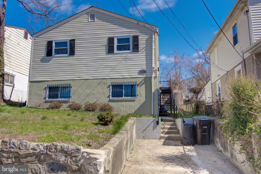 This well-maintained home has the space you want, and the location you need! Features a beautiful kitchen with granite countertops and stainless steel appliances, hardwood on the main level, and a nicely finished basement with 2 bedrooms and full bathroom. Newer sump pump, AC unit, and windows, and solar panels for energy efficiency. Completely renovated in 2016. One block from the DC line -- walk to bus -- 2 mi. to Metro.