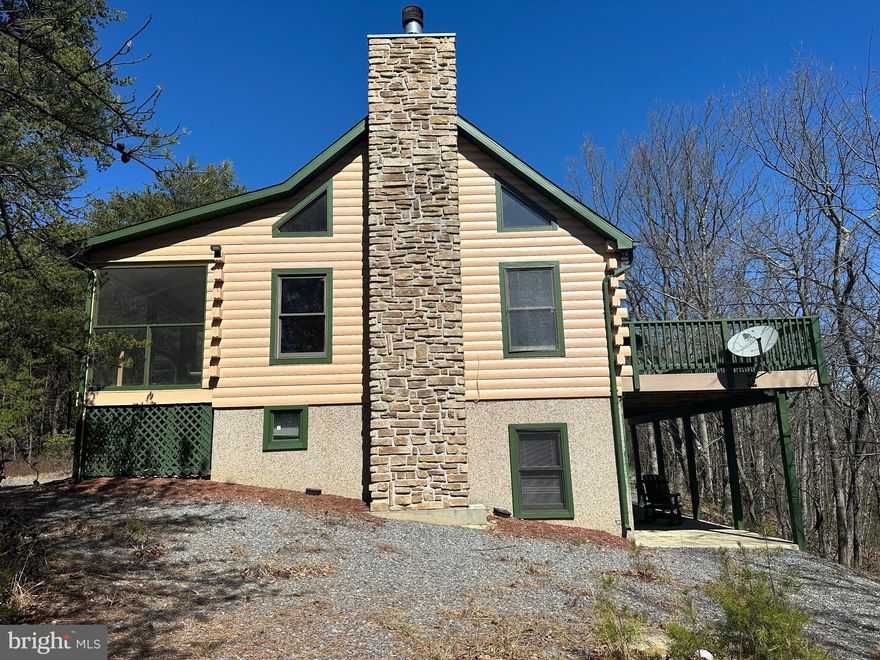 DEAL OF THE DECADE.....ADORABLE LOG CHALET HIDDEN IN THE MIDDLE OF 25 USABLE ACRES WITH PRIVACY TO SPARE. GENTLY ROLLING LAND COVERED IN HARDWOODS, PINES, MT LAUREL, SANDSTONE BOULDERS & ATV TRAILS GALORE WITH 2 SPRING FED WET WEATHER STREAMS. CABIN FEATURES PINE....LOTS OF IT, NO DRYWALL, WOOD BURNING FIREPLACE, HUGE COMPOSITE DECK, SCREENED PORCH AND WHAT YOU SEE IS WHAT YOU GET.....GUN SAFE, SLATE POOL TABLE, BRUSH MOWER & WHAT FURNISHINGS ARE THERE CONVEY. WHY SO CHEAP? THERE'S A DOUBLE SIZED HIGH TENSION POWER LINE ON THE SOUTHERN PROPERTY BOUNDARY APPROX 150 YARDS FROM THE CABIN, YOU CAN SEE THE LINES WHEN THE LEAVES ARE OFF AND YOU CAN SEE THE TOP OF ONE OF THE TOWERS 24/7 365....THOSE ARE THE CONS....THE PROS ARE THAT THE POWERLINE PROVIDES EXCELLENT ATV RIDING, HUNTING, 300+ YARD SHOOTING RANGE AND 12,000 KWH OF FREE ELECTRICITY PER YEAR! FOR A SECOND HOME, YOU'LL PROBABLY NEVER HAVE AN ELECTRIC BILL AND IF YOU LIVE THERE FULL TIME, IT'LL PROBABLY NEVER BE OVER $100 PER MONTH. LOCATED IN THE PRESTIGIOUS 3000 ACRE GATED COMMUNITY OF RIVER RIDGE, ONLY 110 MILES FROM THE WHITE HOUSE, 10 MINUTES FROM THE HAPPENING VILLIAGE OF WARDENSVILLE, TROUT STREAMS, GW NATIONAL FOREST & THE CACAPON & LOST RIVERS AND 30 MINUTES FROM WINCHESTER, VA. GOOD DEALS ARE HARD TO COME BY THESE DAYS, GREAT DEALS NEXT TO IMPOSSIBLE AND DEALS LIKE THIS ARE UNHEARD OF....YOU COULDN'T EVEN REPLICATE THE CABIN FOR 325K. IF THE POWERLINE DEAL FREAKS YOU OUT, THEN SET THIS ONE OUT.....IF IT DOESN'T BOTHER YOU, THEN MAKE THE CALL AND SNAG THIS WHOPPER OF A DEAL BEFORE SOMEONE ELSE BEATS YOU TO THE PUNCH!