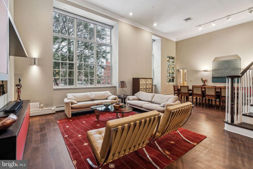Spectacular home with a seamless combination of beautiful original character and modern updates at The Willings at Independence Park in the heart of Society Hill. This beautifully appointed home known as Buford Manor is the largest residence available in the building. It features four bedrooms (or three plus den), three full bathrooms, a powder room, great entertaining space, high ceilings, new hardwood floors, and a deeded parking spot. Upon entering there is a grand foyer with a soaring ceiling, conveniently located powder room, and coat closet that leads to the magnificent great room. The expansive great room enjoys massive windows providing excellent natural light, a beautiful curved staircase that leads to the lofted bedroom/den, a 14-foot high ceiling, and an open living and dining space, perfect for entertaining. Both the living and dining area enjoy recessed lighting and custom built-ins with storage. The dining space can easily fit a 12-person table and has custom built-in display shelves with accent lighting. Adjacent to the dining area is a  modern eat-in kitchen with sleek wood cabinetry, solid surface countertops, instant hot water faucet, breakfast bar, mirrored backsplash, and a state-of-the-art stainless steel appliance package including a Wolf microwave and  oven, Wolf gas range and hood, wood paneled Sub-Zero refrigerator, and ASKO dishwasher. The large primary suite  enjoys more oversized windows, a high ceiling, two walk-in closets and an ensuite marble appointed  bathroom with modern double vanity, bathtub and separate glass enclosed shower. Up a small flight of stairs are two generously  sized bedrooms with oversized windows, high ceilings, and excellent closet space that enjoy use of a full hall bathroom with modern vanity and glass enclosed tub shower. One bedroom is currently being used as an office  and features a full wall of custom built-in shelving and storage. Up the gorgeous curved staircase is the fourth lofted  bedroom that overlooks the great room. It is currently being used as a den and features custom built-ins, a walk-in  closet, and a full ensuite bathroom with modern vanity and glass enclosed tub shower. There is also a laundry room  with side-by-side Maytag washer and dryer and a walk-in storage closet off of the foyer. Additional home highlights include a new HVAC system with Nest thermostat, beautiful trim and millwork, crown and baseboard molding, custom light fixtures, and recessed lighting throughout. A climate controlled storage unit is also included with the home. The Willings at Independence Park is a historic boutique condominium building with only 23 residences offering ornate historic details from the late 1800s and incredible privacy. The Willings named after Thomas Willings was the original headquarters for the Reading Railroad (a property in the game Monopoly!) in 1871 and boasts the largest concentration of original 18th and 19th century architecture in the United States. Residents enjoy a 24-hour doorman, concierge and on-site manager. The building is located in the heart of Society Hill walking distance from Washington Square, Independence Hall, world class dining, shopping, museums, and historic sites.