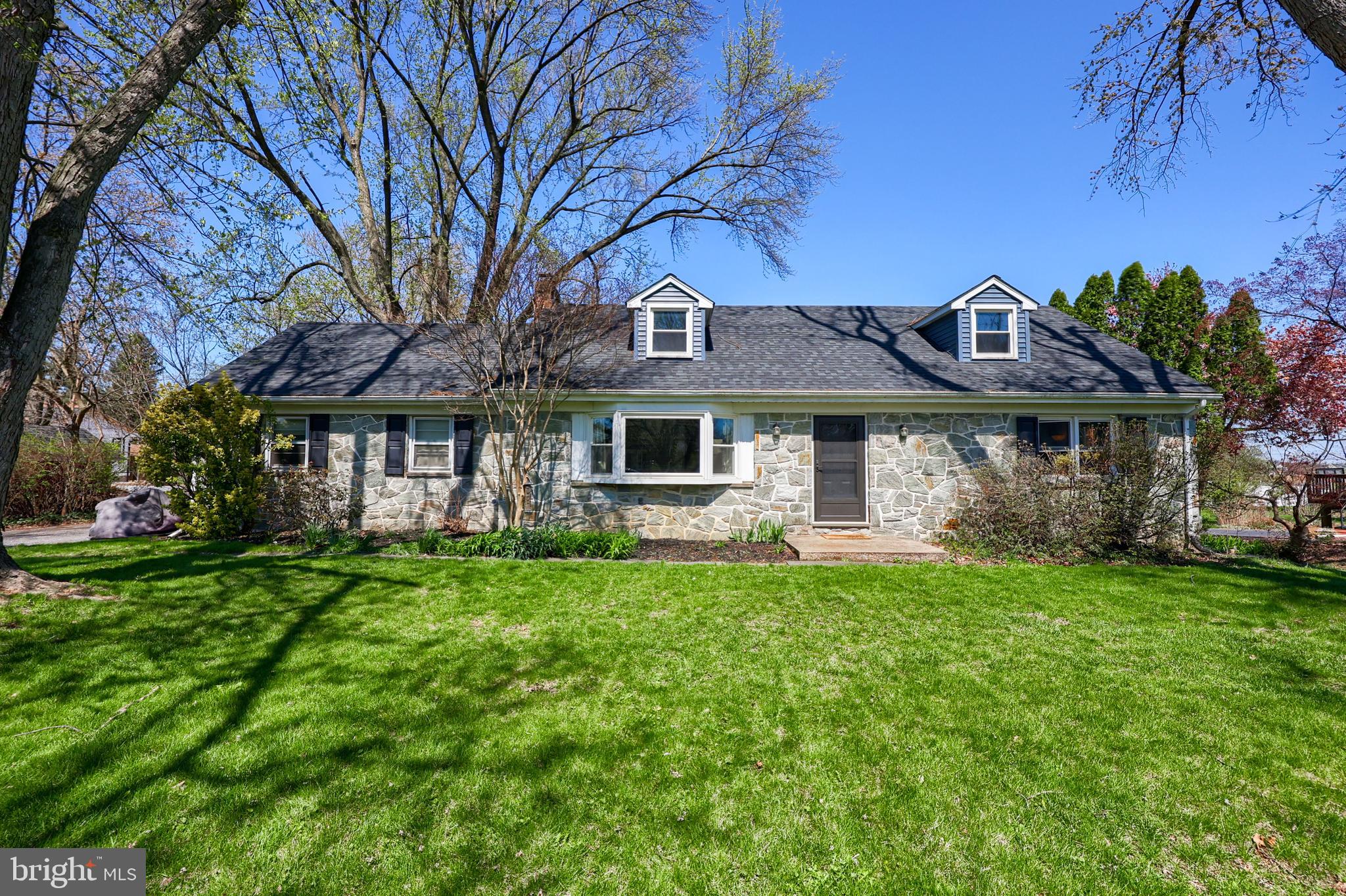 Welcome to the Bloomingdale neighborhood in highly desired Manheim Township. This timeless stone-and-brick Cape Cod sits on a quiet, peaceful street lined with mature trees and yet is conveniently close to everything! Boasting the largest lot on the street spanning over a half acre (.64 acres) and a 2 car garage with an extended driveway to accommodate guests or multiple vehicles. Once inside you will be greeted by what is now a more open floor plan since the owners strategically removed a wall. Refinished original hardwood floors lead to the remodeled kitchen (2015) offering generous counter and cabinet space. Most appealing is the FIRST FLOOR PRIMARY BEDROOM with walk-in closet and upgraded primary ensuite including radiant floor heat, double vanity and walk-in shower (2015). Head upstairs to find yet another full bathroom with double vanity and two large bedrooms sure to be any kids dream space. The walk-out lower level provides a 4th bedroom, ample storage, and a partially finished flex space featuring a cozy wood-burning fireplace—perfect for a family room, game room, or creative studio. Another highlight is the expansive, level backyard ideal for entertaining, gardening and is fully fenced for your kids and pets to run free. Notable RENOVATIONS: all windows and doors in home replaced (2019), new roof, siding and gutters (2021), converted from oil to efficient gas heat (2011), new Central AC unit (2023). Now, to emphasize that this home is in a PRIME LOCATION: hospitals, shopping malls, restaurants and the Lancaster Amtrak Railroad Station- all within a 10 min drive. Surrounded by two golf courses: Overlook Golf Course and The Lancaster Country Club (host of the 2024 US Women's Open). In the mood for community entertainment? Longs Park is a short drive away with an amphitheater that hosts live summer musical productions. For more fun, head to nearby Downtown Lancaster or Lititz to enjoy monthly live music, art exhibits, shops, eateries and festivities! And when it is time to travel, appreciate easy access to major routes: 30, 222, and 283 - perfect for commuting to York, Philadelphia, Harrisburg, Hershey, and Reading PA. Hurry- schedule your showing today and move in just in time to have summer gatherings in your beautiful new home!