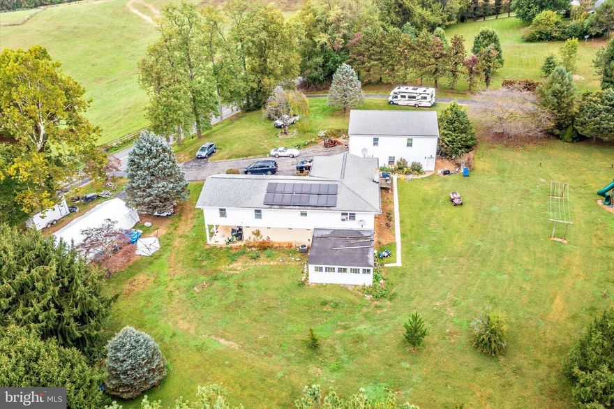 Beautiful 8-Bedroom Home on 5 Acres with Endless Possibilities! Discover this well-maintained 8-bedroom home situated on 5 picturesque acres, offering versatile living arrangements and incredible potential. The main level features 6 spacious bedrooms, 2 full bathrooms, an open-concept kitchen, dining area, and a cozy living room with a wood stove and charming brick accent wall. The lower level is a fully equipped in-law suite, complete with its own kitchen, living room, dining area, 2 bedrooms, and a bright sunroom with a private entrance — perfect for extended family, rental income, or Airbnb opportunities to help offset your mortgage. A large two-car oversized garage includes a finished upper level that’s ready to be transformed into an additional apartment — just add a bathroom and kitchen, and you’ll have even more income potential or guest space. Outdoors, the property is designed for fun, relaxation, and adventure. Enjoy a 900-foot wooden adventure trail that winds through the trees, a playground, and a flat open space ideal for camping, gatherings, or even possible subdivision (buyer to verify). With room for two families, outdoor entertainment areas, and future expansion options, this one-of-a-kind property offers a rare combination of comfort, income potential, and natural beauty.