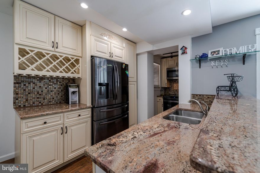 Check out an amazing renovation in the historic district of Dundalk! This semi-detached home offers 3 bedrooms and 2 full baths, a fenced yard, large new deck and convenience of a private parking pad. The front façade has been upgraded in a lovely light grey stone. Welcome guests into the open living  & dining area which leads to the kitchen with new granite countertops, mosaic tile backsplash and accents, breakfast bar and stainless appliances. The basement features a third bedroom with a closet organization system,  and bath with modern fixtures as well as a laundry area. Two large bedrooms and a full bath with shower upstairs make this a great starter home. Quality features and modern design choices at a great value!