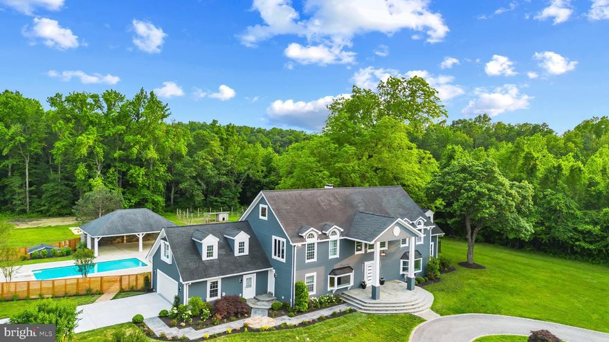 Impressive estate with private pool oasis on 11 acres of land.  Boasting 157 ft of shoreline on Brewers Creek, this 5,000+ sqft, 5 bedroom 4.5 bath home has been completely refreshed with new paint and flooring throughout. The beautiful coffered ceiling and wainscoting highlights the incredible attention to detail and quality workmanship to create a home of distinction. The  top-of-the-line chef's Kitchen which flows easily into the Dining Room features a unique and charming brick archway, large island and views of the pool beyond. Five bedrooms and 4 baths adorn the upper floor including the luxurious Primary suite with expansive balcony, bucolic views and spa-like bath with double sinks and 2 large walk-in closet. Additionally, a spacious bonus room with vaulted ceilings, full bath, sitting area and kitchenette provides endless options to suit your families needs. Head outside to the fabulous pool are with covered patio, outdoor kitchen, fireplace and pavilion, the perfect place to spend the summer.  The adjacent sand volleyball pit guarantees a fun time for all! Enjoy the opportunity to house animals of all kinds in the barn with horse stables, large chicken coop and numerous outbuildings.  The apartment above the barn has 2 bedrooms, a full bath and kitchen making accommodating numerous guests easy and convenient. The deep water pier (5ft MLW), with boat lift and multi-slips will be sure to please any boating enthusiast. Located in the ideal location for quickly accessing the South River or Chesapeake Bay by boat, heading by car to Historic Annapolis or hopping on Rt. 50 to get back to Washington, DC. This is the private waterfront oasis you have been waiting for. Welcome Home!