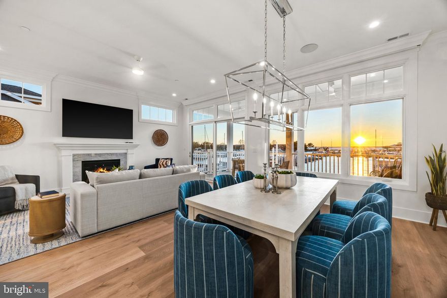 Welcome to Sunset Wharf, a refined waterfront enclave set within the picturesque Bay Bridge Marina, where coastal living is defined by sweeping views and effortless sophistication. This fully completed residence is one of just a select offering within the initial collection of three buildings, each thoughtfully designed with only two residences each, creating an intimate and private setting along the water’s edge.

Inside, the home unfolds across three levels with a thoughtfully designed four bedroom, four bath layout that offers both flexibility and comfort. A private bedroom and full bath on the entry level provide the perfect space for guests or a quiet home office. The main living level is designed for seamless everyday living and entertaining, highlighted by a warm and inviting living room with a gas fireplace that adds both comfort and ambiance. The upper level features two additional bedroom suites, including a serene primary retreat complete with its own gas fireplace. An elegant touch that enhances the sense of relaxation and retreat.

Expansive windows frame captivating views over the marina and out to the Chesapeake Bay, filling the home with natural light and creating an ever-changing backdrop of boating activity and open water. As the day winds down, the setting truly comes to life with breathtaking sunsets that paint the sky and reflect across the water. An experience to be enjoyed from both the interior living spaces and outdoor areas.

High-end finishes and a modern, open-concept design elevate the interiors, while the beautifully appointed gourmet kitchen and well designed baths enhance both form and function. Every detail has been curated to deliver a low-maintenance, lock-and-go lifestyle without compromising on luxury.

Ideally positioned within walking distance to waterfront dining, including Libbey’s Coastal Kitchen & Cocktails and Knoxie’s Table, residents also enjoy immediate access to marina amenities, scenic walking paths, and the relaxed rhythm of life on the Bay. Sunset Wharf offers a rare opportunity to own a newly completed residence in a thoughtfully designed waterfront community where every day feels like a getaway. Welcome Home!