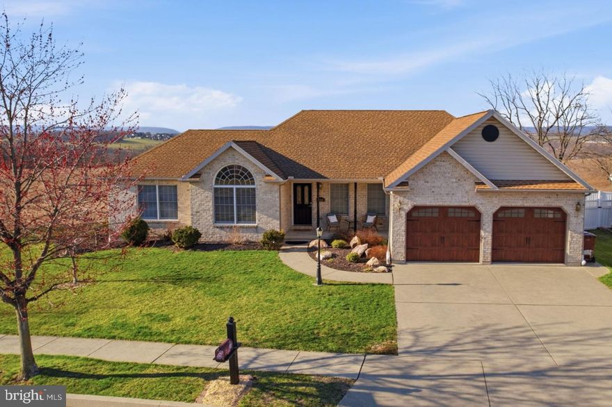 Welcome to a masterclass in serene, high-end living within the desirable Eagles Nest community. Perched on a choice corner lot, this absolutely picturesque Brick Ranch by Hanover Homes represents a rare convergence of architectural quality and an out-of-this-world natural setting. While the property sits on a manageable lot of over a quarter acre, its unique position provides breathtaking views of the rolling hills, creating a peaceful and private setting. As you pass through the front doors, you are immediately greeted by a sophisticated open-concept layout that prioritizes volume and light. The Heart of the Home is an Extra Large Living Room, anchored by a cozy gas fireplace and framed by towering windows that act as live canvases for the undulating hills outside. This is a space designed for both quiet reflection and grand-scale hosting, where the boundaries between the elegant interior and the pastoral scenery begin to blur.
For the culinary enthusiast, the Luxury Kitchen is a triumph of form and function. It conveniently offers a bright Eat-In space for casual mornings, while transitioning seamlessly into a Large Formal Dining Room for sophisticated evening soirées. Whether you are preparing a simple meal or catering a holiday event, the flow of the main level ensures the chef is always part of the conversation.
The Primary Bedroom Suite is a true sanctuary, designed to blow you away with its sheer scale and thoughtful amenities. It features a Large Luxury Bathroom and a spacious Walk-In Closet, but the true highlight is the massive, private Sitting Area. Flooded with natural sunlight and offering panoramic views of the neighboring farm, this versatile space is the ultimate retreat for a morning yoga practice, a home library, or a secondary lounge to watch the sun set in total seclusion. Two additional well-appointed Bedrooms and a total of three and a half Bathrooms ensure that guests and family members enjoy the same level of comfort.
The Massive Finished Lower Level is an unbelievable flex space limited only by your imagination. With enough room to house a professional-grade workout facility, a home cinema, a billiards lounge, and a dedicated Recreation Room simultaneously, it serves as the ultimate entertainment hub. This lower level is not just extra square footage; it is a lifestyle destination within your own four walls.
The outdoor living spaces have been recently upgraded to perfectly complement the home's interior. A brand-new Trex Deck provides a low-maintenance platform for alfresco dining, while the expansive Paver Patio below offers an elegant space for fire pit gatherings under the stars. Both levels serve as the ultimate vantage point to take in the quiet beauty of the countryside and those truly epic, long-range views. *Enclosed porch photo has been virtually staged.