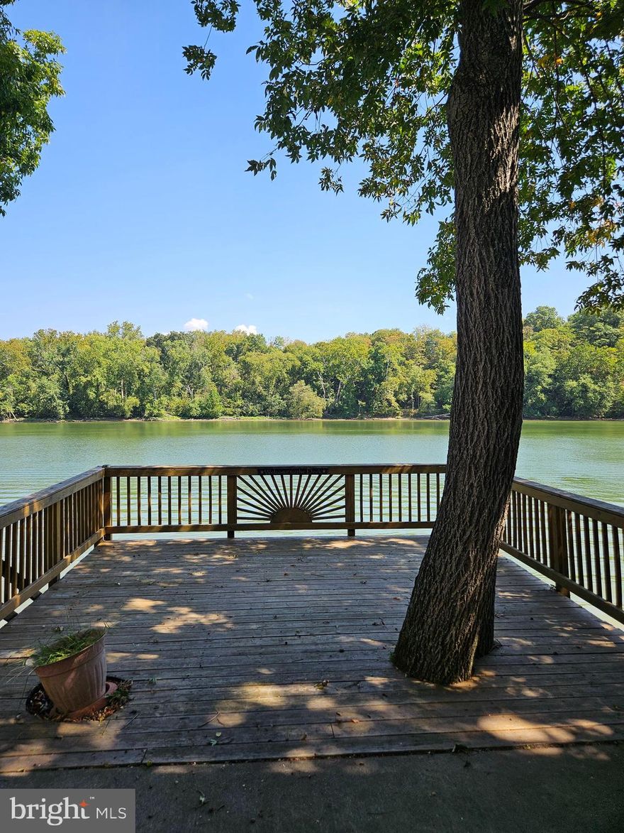 Welcome to Block 1 lot 35 Boo Boo Blvd in Riverbends Rv Campground. Riverbend is 400 Acres of SEASONAL recreational campground full of amenities located on the Potomac River in Falling Waters, Wv. OPEN APRIL 1 - NOVEMBER 1 - This is a fun & entertaining community, yet relaxing. This lot is stunning located right on the Potomac River with direct access including a Pontoon Dock and Catwalk to walk right out to your boat! MUST SELL
This lot features a large concrete pad and surrounded by gravel making it almost Maintenace free! Just come, enjoy, relax and make memories right under the large stick-built Pavilion with lean to covering an outdoor kitchen area, 5th wheel camper that has been kept in great condition, gas Club Cart (4 seater) The Pavilion is fully wired with electric outlets and ceiling fans to keep that fresh air coming off of the river flowing. There is plenty of parking on the gravel driveway space. Everything you see conveys, including the shed. Come spend time on the deck overlooking the river and built on a solid concrete wall and you will feel right at home here. The lot next door is also for sale Block 1 lot 36. These can be purchased together, making it perfect for a group of friends or family to create memories side by side! Call today for your personal tour. Approx. 10 miles of Deep water on the Potomac River access for boating, fishing & swimming. Yearly membership ($1,987) plus a $200 initiation fee for new owners, includes water, Pump outs, electric, trash and the park amenities such as 3 pools, putt putt course, Horseshoe club, Boat club, Poker runs, Trick or Treat, Christmas in July, live bands, basketball court, tennis court, fireworks, car show, Church, restaurant, bar, convenience store (Great food), playground, volleyball, ball field and much much more. Bring your golf carts, water toys and come enjoy life!