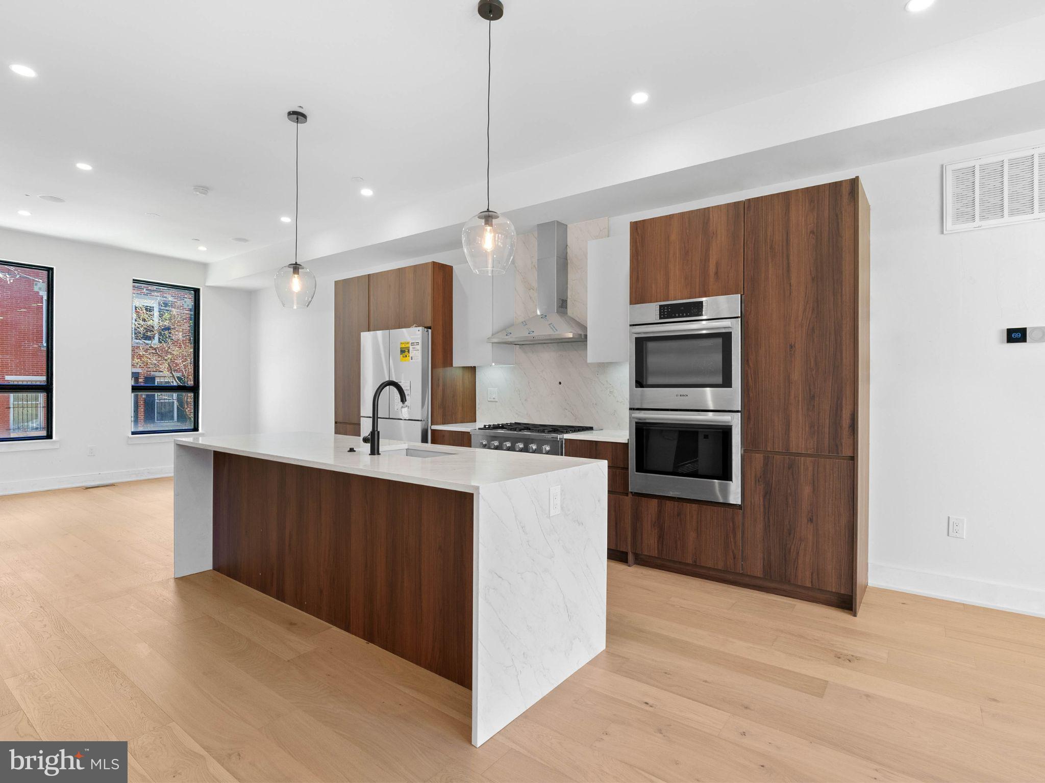 ONLY TWO HOMES LEFT! Extra large, 20 foot wide new home with at Artist Village, Philadelphia's brand new community of spectacular stately residences. With its prominent location at 17th & Bainbridge Streets in the heart of the historic Graduate Hospital, this unique enclave of homes will transform an entire city, bringing new life to a treasured neighborhood. Artist Village offers twelve luxury townhomes running parallel down 17th St and Colorado St. Each residence has been expertly designed, by JKRP Architects, with a layout that perfectly blends form with function. Every home will have private 1-2 car garage parking, an expansive roof deck - three outdoor spaces total, a tax abatement, elevators in the 17th Street homes and smart-home technology throughout plus the homes on 17th Street each have an elevator! A handsome brick facade greets you at the home's exterior. Once inside, you'll discover a completely open main level with a living room and dining area filled with natural light from tall windows. The stunning chef's kitchen, adorned with top-of-the-line appliances, custom cabinetry, and designer finishes, is sure to become the heart of the home! The lower level has the all-important 1-2 car garage parking and a bonus space ideal for a home theater, playroom, or gym. The second level has two bright bedrooms, two full bathrooms, and a conveniently located laundry closet. The primary suite covers the entire third level, acting as a private retreat. There's a large bedroom with great natural light, a custom walk-in closet with space to share, and a luxurious bathroom fitted with a double vanity, soaking tub, rainfall shower, and a water closet. Topping off this amazing home is a one-of-a-kind bi-level roof deck! With a powder room and wet bar equipped pilot house, tons of space to spread out, and mesmerizing views of the city, this is an entertainer's paradise! Not only is Artist Village a fantastic development, it's in an equally fantastic neighborhood. This highly sought-after Graduate Hospital location earns a WalkScore of 97! Nearby, South Street is lined with local restaurants, shops, and markets. Fine dining, luxury shopping, and lively entertainment can be found in neighboring Rittenhouse Sq, plus Target, Sprouts Farmers Market, and Wine & Spirits are less than a 10-minute walk. This central location also provides easy access to Broad St, Washington Ave, Jefferson Hospital, Pennsylvania Hospital, University City, and I-76. Artist Village presents a rare opportunity not to be missed. The time is now to reserve your home, customize your finishes, and plant your roots in Graduate Hospital's next chapter. The top floor flex space can easily be converted into a fourth bedroom; a door can be added for privacy. Taxes are not $1. Association fees, Taxes and square footage are the responsibility of the buyer to have verified independently. The PAR Standard Agreement of Sale for New Construction of sale must be used for new construction properties whether completed or not.