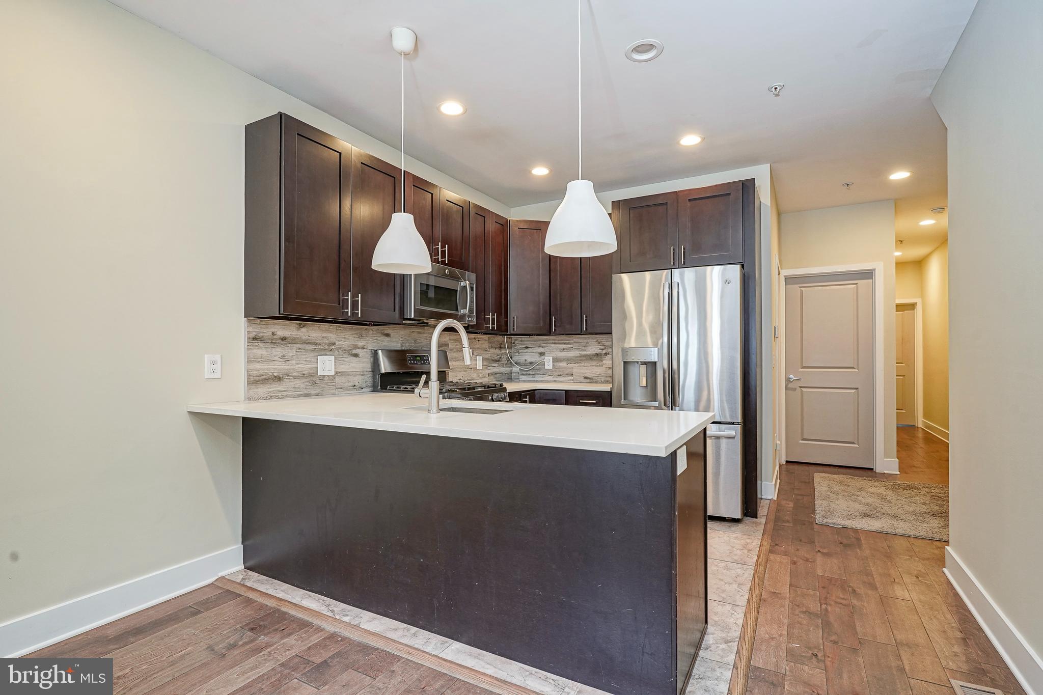 Seller is motivated to sell! Come discover spacious, modern city living in this beautifully designed first-floor condo in vibrant Brewerytown. Built in 2016 and just one block from the thriving West Girard Avenue corridor, this 3-bedroom, 2-bath home offers comfort, style, and unbeatable convenience.
Set on two full levels, Unit A features hardwood floors, recessed lighting, and elegant wrought iron details throughout. The main level welcomes you with a large kitchen complete with quartz countertops, espresso cabinets, stainless steel appliances, a high-arch chef’s faucet, porcelain backsplash, and chic pendant lighting — perfect for home chefs and entertainers alike.
Toward the rear, two spacious bedrooms include ceiling fans and generous closet space, alongside a modern full bathroom. Step outside to your private rear yard — a rare bonus in city living.
Downstairs, enjoy full ownership of the finished lower level, featuring a third bedroom and full bath ideal for guests or extended stays. A wide open entertainment area with a striking stone faux fireplace adds warmth and flexibility, while separate laundry and mechanical rooms enhance everyday convenience.
Located steps from Fairmount Park, with upgraded sidewalks and lighting all around, this home offers easy access to grocery stores, major highways, and public transit, including a trolley connection to Northern Liberties and Fishtown.
Enjoy the best of Brewerytown living — stylish, spacious, and connected to it all.