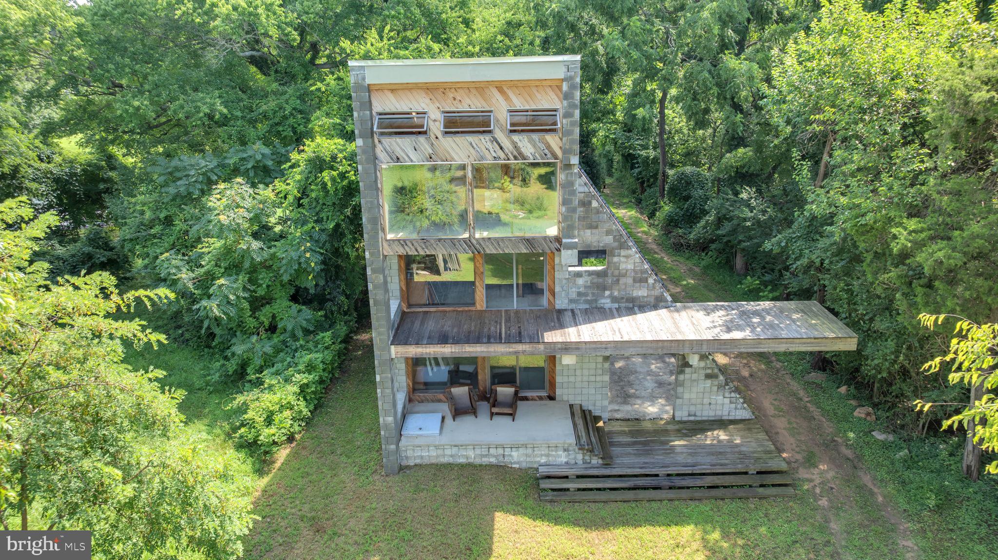 Welcome to POTOMAC RIVER WATERFRONT CROSSWAKE HOUSE—an architect-designed contemporary waterfront retreat that blends timeless European style with the beauty of the American landscape. Thoughtfully built with natural, durable materials like cedar siding, aluminum roofing, and radiant-heated concrete floors, this unique home features two wings—one for living and entertaining, the other for rest and privacy. Enjoy peaceful indoor and outdoor spaces with high cathedral ceilings, large picture windows, multiple decks, and beautiful unobstructed water views of the Potomac River. Designed to work with nature, the home is naturally ventilated, energy-efficient, and ready for future upgrades like solar or geothermal. Located in a quiet waterfront community just 40 minutes from D.C. by car and only 30 mins by boat. It's a one-of-a-kind home made for comfort and connection to the outdoors. This home is 75% complete and will need to be finished by the new owner. Seller will provide all architectural plans, designs and blueprints at settlement. Home is being sold AS IS. ***DO NOT ENTER THE PROPERTY WITHOUT AN APPOINTMENT***THERE ARE NO RAILINGS AT UPPER LEVEL CANTILEVERS***