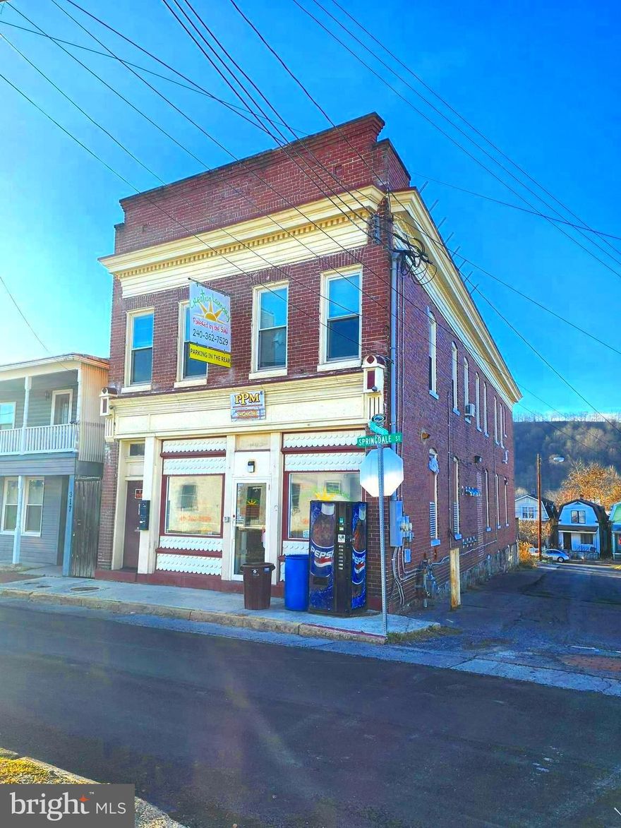 ALL UNITS RENTED!!!  AMAZING BUSINESS OPPORTUNITY!  Turn Key!   Over 4100 fin. sq ft. This property once operated as a laundry mat on the main level!   A LARGE parking lot (5+ spaces) in the rear!  Two apartments on the upper level.  Apt. A pays $750 per month and Apt. B pays $750 per month.  Tenants pay  electric.  Apartments heat with electric baseboard.  Building does have gas heat as well.   Central Air.  SOLAR PANELS are owned by the seller and will convey with the sale of the property!  The HUGE basement has ample storage space!  Income producing property!  Main level is currently being rented as storage space.  Call today to schedule a tour.