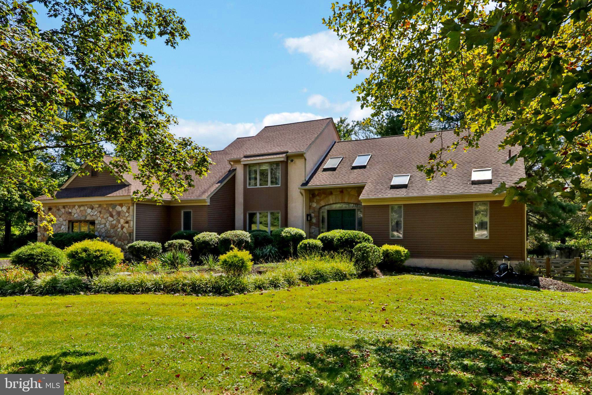Elegant 4BR Contemporary in Coveted Spring Oak Estates
Tucked away on a lush, landscaped plus acre at the end of a quiet cul-de-sac, this beautifully updated home offers privacy, charm, and refined living in one of the area’s most prestigious neighborhoods.
Step into a dramatic two-story foyer with skylights and a striking modern light fixture. Fresh paint, custom board-and-batten accents, and newer carpet elevate the space with timeless style. The first-floor primary suite is a true retreat—featuring new luxury flooring, a sunlit spa-like bath with skylights, glass shower, jacuzzi tub, and even a mounted TV for soaking in comfort. The living room impresses with vaulted ceilings, skylights, a marble fireplace, and fresh finishes. Formal dining shines with wainscoting, crown molding, and a large window overlooking the serene front yard. The gourmet kitchen boasts granite counters, stainless steel appliances (refrigerator included), more than ample cabinetry, and a breakfast bar with stools. The adjacent family room is a showstopper—soaring wood-beamed ceilings, a dramatic stone fireplace, and two oversized sliding French doors with retractable screens that let so much fresh air in and sunlight yet the outside elements out and step out to a spacious cedar deck and partially fenced yard with new split-rail fencing. Off the kitchen hall, you'll find a freshly updated powder room, a bright laundry room with washer and dryer included, a pantry closet, and convenient access to the 2 plus car attached garage—making everyday living beautifully efficient.
Upstairs, three bright bedrooms feature recessed lighting, ceiling fans, and generous closets. A spiral staircase leads to a versatile loft—perfect for a playroom, studio, or home office and nice sized bathroom .
Lower Level Bonus
The finished daylight walk-out basement offers exceptional space and warmth, highlighted by a spectacular hand-carved wood fireplace and expansive storage areas—ideal for entertaining, hobbies, or cozy evenings in. Plenty of space available to add another bedroom, offices or bath in the lower level if desired.
Additional highlights: tankless water heater, freshly sealed driveway, and recently serviced HVAC with warranty and Leaf guard install for gutters. Located in award-winning Rose Tree Media SD, just minutes from downtown Media’s shops, dining, and events. Low taxes, impeccable upkeep, and move-in-ready condition make this home a rare find.