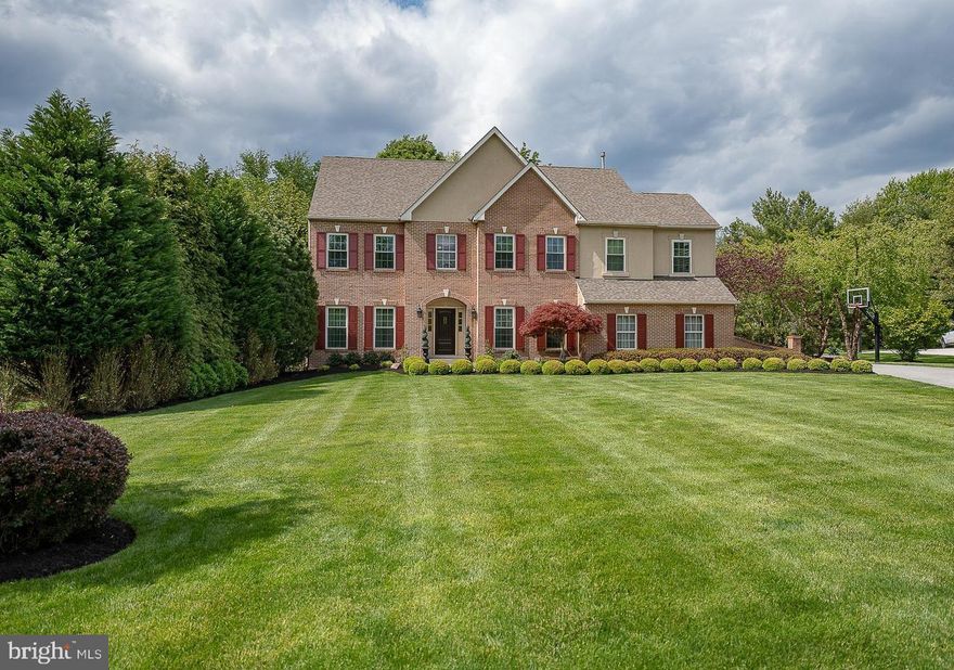 Privately set on a lushly landscaped .58-acre cul-de-sac lot, this exceptional brick-front estate offers a rare blend of timeless elegance, resort-inspired outdoor living, and curated interior spaces. Featuring over 4,200 square feet, 5 bedrooms, and 4.5 baths, the home delivers an elevated lifestyle designed for both sophisticated entertaining and comfortable everyday living.

A dramatic two-story foyer and dual staircase welcome you into spacious, light-filled interiors featuring abundant natural light, rich hardwood flooring, custom millwork, detailed wainscoting, extensive built-ins, and refined architectural finishes throughout. The open-concept layout is thoughtfully designed for grand-scale entertaining and comfortable everyday living, offering exceptional spaces for every occasion.

At the heart of the home, the chef’s kitchen is beautifully appointed with granite countertops, a center island, stainless steel appliances, a combined espresso and wine bar, and generous gathering space that flows seamlessly into the main living and entertaining areas. Custom organizational systems and closets throughout the home, including the pantry and mudroom, provide exceptional functionality and thoughtful everyday convenience. Just beyond the kitchen, the formal dining room creates an elegant setting for holidays, dinner parties, and special occasions.

The stunning family room is a showpiece, featuring soaring cathedral ceilings, a fireplace, and arched windows that frame panoramic views of the breathtaking resort-style backyard, creating a seamless connection between indoor luxury and outdoor living.

A private main-level office with French doors provides the ideal work-from-home retreat, while the formal living room offers an additional elegant gathering space filled with warmth, character, and flexibility for entertaining.

The beautifully finished lower level is equally impressive, complete with a large center island, custom wine bar, dishwasher, microwave, fireplace, full bath, and premium finishes throughout, creating the perfect setting for game days, entertaining, extended guest stays, or relaxed evenings at home, along with abundant additional storage space.

The primary suite offers a luxurious private retreat featuring dual walk-in closets and a spa-inspired bath with a sunken tub, stall shower, separate water closet, dedicated linen storage, and elegant tray ceilings that add architectural character and dimension to the space.

The third floor provides exceptional flexibility and privacy, offering a fifth bedroom, a full bath, an additional sitting room with a beverage refrigerator, and a separate private office. Ideal for extended guests, multigenerational living, an au pair suite, or a private work-from-home retreat.

Step outside to an extraordinary backyard oasis designed for resort-style living. Set within an expansive, landscaped backyard surrounded by mature trees and lush greenery, this incredibly private setting offers the feeling of a secluded retreat. The outdoor space features a heated saltwater pool and spa, expansive patios, an outdoor stone fireplace and lounge area, and multiple entertaining spaces thoughtfully designed for relaxing, hosting, and enjoying summer to its fullest.

From summer gatherings by the pool to cozy evenings beside the fireplaces, every level of the home offers its own sense of comfort, privacy, and connection.

Additional highlights include an oversized side-entry two-car garage, a fenced yard with a storage shed, a water filtration and softener system, a newer roof, replacement windows, updated HVAC, a tankless water heater, driveway and garage door improvements, and numerous additional mechanical and structural upgrades.

Conveniently located minutes from Routes 476 and 76, KOP dining and shopping, the R5 and R6 regional rail lines to Philadelphia, and high-speed rail service to NYC, this exceptional residence offers luxury, privacy, and convenience.