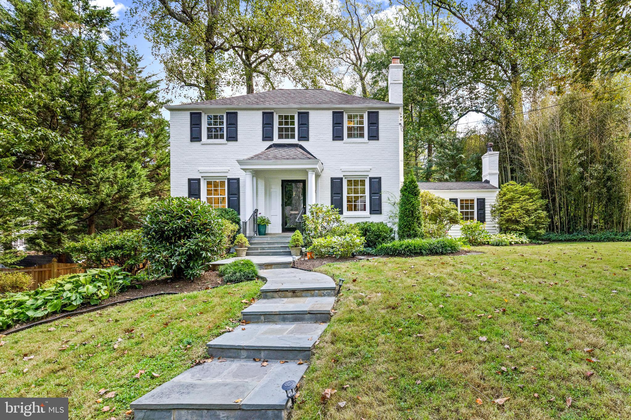 Situated on a beautiful tree-lined street in the highly desirable Woodacres neighborhood of Bethesda, this 4 bedroom / 3.5 bathroom classic white Colonial elegantly sits on a .2 acre lot boasting impeccable 1940s architectural details that blend seamlessly with its modern updates.
The main level offers a sun-drenched living room with a wood-burning fireplace, a separate formal dining room with a bay window, a cozy family room with built-ins, another fireplace and second bay window; as well as a renovated eat-in kitchen (2020) that has beautifully updated countertops and stainless-steel appliances with custom panels. The kitchen is flooded with sunlight and includes a built-in banquet under the third bay window for informal dining, a peninsula with seating for two, an abundance of storage and a side entrance door leading down to the driveway. Also on this level is a powder room and a back entrance door to the patio.
The upper level features three bedrooms - the corner primary suite with two closets and an en-suite bathroom as well as two additional generous-sized corner bedrooms that each have a closet. Completing this level is a hallway bathroom with a bathtub, access to the attic and a linen closet.
The lower level of the home is finished and walks out to the driveway, providing easy access and daylight. There is a recreation room, the fourth bedroom with a closet and separate entrance door to the driveway, a full hallway bathroom and a large utility / laundry room with a new side-by-side washer and dryer (2023). The majority of the home is covered in hardwood flooring and most of the windows have been replaced (2020).
Incredibly rare, this home provides a long and paved driveway with parking for 4-5 cars. There is a covered storage area under the side stairs for gardening tools and trash / recycling. The back patio is private and perfect for Al fresco dining and entertaining - looking out into the majestic mature landscaping. Just beyond the patio is an elevated back lawn surrounded by trees. The front lawn is flat and large in scale with lush landscaping on the perimeter.
Located just minutes from Woodacres Park, Wood Acres Elementary School, Pyle Middle School and Walt-Whitman High School as well as a short distance to the Capital-Crescent Trail, C&O Canal, Potomac River, Sangamore Shopping Center, Whole Foods, Downtown Bethesda and soon-to-be Westbard Square – the proximity to all your needs does not get any better. Woodacres is a truly charming community with holiday gatherings, parades, neighborhood events and food trucks!!