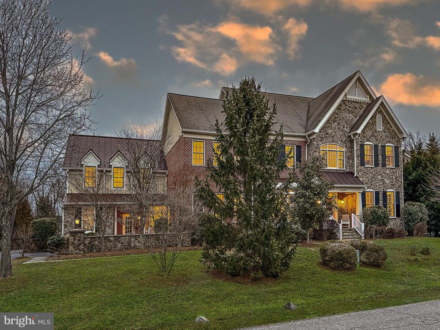 Rarely available Goose Creek Bend with even rarer 1.13 acre estate lot.  Mature trees and landscaping for privacy and enjoying nature.  Perfect level lot for a future pool.  Brick, stone and Hardiplank exterior, partial metal roof lend to the custom estate feel of this home.   Over 8,400 square feet on three finished levels, 3 car side-load garage.  Mudroom entry with guest parking and a stone wall for privacy.  Neighborhood access trail to Goose Creek.

Upon entering, you are greeted by a grand foyer that sets the tone for the high-end finishes and pristine random-width hardwoods found throughout the home.  Ten foot ceilings on main with beefy moldings and trim. The gourmet kitchen is a chef's dream, boasting a unique vaulted ceiling, granite countertops, a cooktop, wall oven, and an oversized island with seating.  Breakfast area with double-sided fireplace.  Butler's pantry, mudroom with separate entrance,  large walk-in pantry.  Two half baths on the main level.  Back staircase with hardwoods to the upper level.  Easily create a main-level bedroom (it was an option from the builder so the space is there).

The expansive family room, with its wall of windows and gas fireplace, offers a cozy yet luxurious setting. A private den serves as an ideal office space. Formal living and oversized dining room for large gatherings.

Upstairs, the primary suite features a private sitting room (possible 5th bedroom up that was an option with the builder), dual walk-in closets, and a luxurious bath. An additional private guest suite and loft area used as an office provide ample living space. Four generous bedrooms with three fulls baths on the upper level including the laundry room.  The finished lower level includes a legal fifth bedroom, a fourth full bath, a billiards room, media room and plenty of storage.  Au pair suite or guest suite in the lower level.

With over $100,000 in outdoor improvements, the outdoor living space features a newer patio, pergola, deck, and fenced yard.  Great entertaining space with a stone fire pit, and several seating areas for cozy gatherings or larger parties.  Public water and sewer.  Located just off the Dulles Toll Rd. and Sycolin Rd. with easy access to commuter routes and Ashburn/Leesburg. 15 minutes to Dulles Airport.  New amazing price for this square footage!