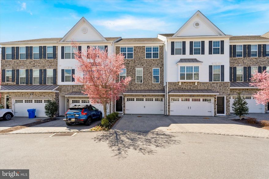 Enjoy the best of convenient, low-maintenance living in this beautifully upgraded Bethesda Georgetown model townhouse, located in the sought-after Ravenscliff at Media community. This 3-4 bedroom, 2.5-bath home offers over 2,600 square feet of sun-drenched living space, with soaring 9-foot ceilings and large windows that fill the home with natural light. The attractive stone-front exterior leads to an oversized two-car garage, fully equipped for an electric vehicle, plus a driveway with space for two additional cars.
Inside, a stunning two-story foyer welcomes you, guiding you past a stylish powder room to the main level. The open-concept living and dining area flows seamlessly into the family room, where a gas fireplace creates a warm and inviting ambiance. The chef’s kitchen is a true standout, featuring an extra-large island with upgraded marble countertops and backsplash, a spacious breakfast bar overhang, recessed lighting, and premium appliances, including a five-burner gas cooktop and a stainless steel counter-depth refrigerator. Additional upgrades include wood cabinetry with under-cabinet lighting, pull-out drawers, and modern fixtures & hardware. Just off the kitchen, a low-maintenance composite deck provides the perfect space for outdoor relaxation and grilling.
A private office (or optional fourth bedroom) is conveniently located on the entrance level, along with a coat closet and direct garage access. This home also boasts a daylight walk-out basement, offering the potential for additional living space.
On the top floor, the spacious primary suite impresses with a vaulted ceiling, a huge walk-in closet, and a luxurious en-suite bath with an oversized frameless glass shower featuring marble tile and dual shower-heads, a double vanity with custom cabinetry, a private water closet, and a linen closet. Two additional generously sized bedrooms share a well-appointed hall bath. For added convenience, the laundry area with a full-size washer & dryer is also located on this level.
Positioned on an outer loop of the community, this home offers breathtaking southern views from the primary suite. Built in 2017, this nearly new home is just minutes from Center City, the airport, the Blue Route, and Media’s vibrant shops, restaurants, and train station. With countless upgrades and thoughtful details throughout, this home is truly move-in ready. A full list of additional upgrades is available upon request.