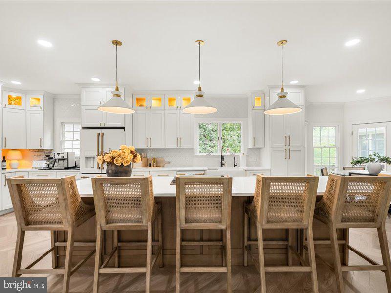 Tucked away on a private 2.7-acre wooded lot, this stunning all-brick colonial has been fully renovated from top to bottom. Inside, 3/4" solid ash, 5"wide herringbone flooring flows throughout, accented by designer lighting, crown molding, and elegant chair rail trim. The chef’s kitchen is a true showstopper—featuring a massive island, striking white and gold appliances, and custom finishes. The cozy living room centers around a fireplace, while a spacious mudroom and laundry area offers ample cabinetry, a utility sink, and built-in organization. Upstairs, the spacious primary suite features a walk-in closet and a spa-like bath with a walk-in shower, standalone soaking tub, and double vanity. Enjoy the beautiful yard from the spacious deck or relax in the screened-in porch, the perfect spot to sip your favorite drink and listen to the birds sing. This turnkey home blends timeless design with modern sophistication in an idyllic natural setting. **See attached invoice from 2024 where septic was inspected and repaired.