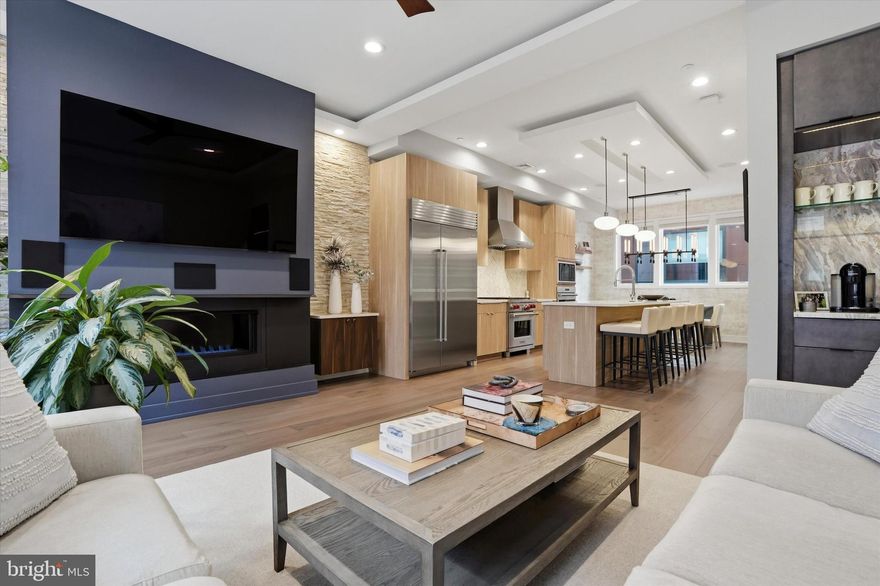 Introducing 611 N Galloway St – a custom-built home tucked away on a quaint, quiet side street in the heart of Northern Liberties. As you step inside you are greeted by a spacious foyer, completed with a coat closet, powder room, and direct access to your oversized one car garage. As you head upstairs, you’ll notice the gorgeous floating staircase that takes you to the main level of the home. This level has been thoughtfully designed, featuring a living room with a custom-built fireplace and beautifully crafted cabinetry. The living room has access to your first outdoor space – a balcony perfect for grilling or enjoying your morning coffee. Natural light pours in from the large windows and can be felt throughout the entire level. The kitchen has been built with top of the line cabinetry, quartz countertops, gorgeous designer tile for the backsplash along with high-end appliances including a sub zero wine fridge. An island creates another sitting area on this level – and is complete with spectacular pendant lighting. Past the kitchen you’ll fall in love with your dining room – where you can easily sit eight. An elegant chandelier completes this space. As you head upstairs the wide plank flooring continues and you are greeted by the primary suite. The bedroom features a custom-made accent wall and access to your second outdoor space – another private balcony. The walk in closet is customized and takes you into the en suite bathroom.  Created with beautiful tile – the spa-like bathroom includes a walk in shower, separate soaking tub, and a double vanity sink. Laundry is also conveniently located on this level. On the next floor you’ll find two spacious bedrooms, with spacious custom-built closets along with your home’s second full bathroom. The top and final level features a pilot house with a dry bar, leading out to the private roof deck with stunning skyline and bridge views, as well as a thoughtfully designed green roof. Heading back downstairs, a large finished basement completes the home and offers the perfect space for a convenient home gym, home office, or cozy home theater. With a built-in speaker system throughout the entire home, you can truly enjoy seamless sound whether you're entertaining guests or relaxing in your own space. This home also benefits from time remaining on the 10-year tax abatement, offering the new owner valuable tax savings. Northern Liberties offers a strong sense of community with unbeatable convenience: 611 Galloway is just steps from coffee shops, restaurants, parks, and grocery stores, with easy access to SEPTA, I-95, and the Ben Franklin Bridge for a seamless commute.