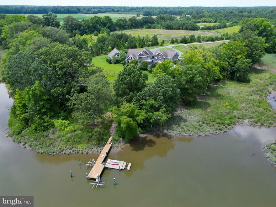 Nature's Reach - exceedingly exceptional waterfront  Tidewater Modern Farmhouse ensconced on 28 +  acres on the upper Miles River providing  sanctuary from the noisy world. Designed by Pam Gardner, this stunning 6400 + sf   3 distinct living spaces, connected by glass hyphens integrating nature and design and boasting 5 bedrooms, 5.5 baths,  great room, dining room,  loft, 2 offices,  bonus room, workshop/studio & exercise room.  Interior features  include  New England fieldstone fireplace, beamed & vaulted ceilings  and reclaimed heart of pine floors.  Abundant outdoor space encompassing a  waterside  screened porch,  multi level patios,  balcony,  pool and spa. Main wing houses the gourmet cooks kitchen with large center island, bar, stainless appliances, 4 burner +griddle  Wolf stove, separate pantry &  abundant custom cabinets that open  into dining and great room spaces with fabulous water views that is  truly the heart of the home! Great room with  Oversized  New England  fieldstone fireplace, vaulted beamed wood ceilings, balcony overlook, waterside  dining room,   second office and 2 bedrooms with baths, sitting room and balcony overlooking the great room.   Located in a separate wing the private first floor primary has vaulted ceilings,  dual walk in closets, luxurious primary bath with spa tub, dual vanities and walk-in shower.  Primary wing includes separate office,  relaxing  loft space and private side porch.  The third wing houses an exercise room, full bath that services  the pool & spa, workshop and 2 additional bedrooms, additional full bath  and bonus room.  Each wing  affords  comfortable gathering and private spaces.  Additional amenities include the  inground lap 15' x 50' pool & spa, 2.5 car garage, separate 16 x 9x 12 barn with 7 x  20 x 8 lean to,  indoor/ outdoor kennel, pier with lifts & kayak launch.   Property has had much care given to rewilding providing extensive habitat for waterfowl and upland game.  Improvements include a  4 + acre impoundment, wetlands,  uplands, several nature trails, extensive  warm season grasses, wildflower meadows with mature seed bank,  flowering fruit trees and 2 acre pecan orchard.  With over 250 ' of shoreline, located in the migration,  this property attracts abundant waterfowl.   Ideal for  outdoor enthusiasts, nature lovers  and hunters alike! 4.5 acres are enrolled in  the CRP program with the CRP contract to be assumed by buyer at settlement. This is truly a nature lover's paradise!