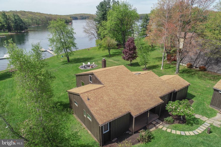 Premium lakefront in a Premium Location!   If you are looking for prime lake-frontage this is a must see.  Located on a peaceful cove with level lakefront, a private Type A boat dock,  and expansive lake views, the 4 bedroom 2 bath cottage with detached 2-car garage offers a convenient location, expansive views from almost every room and great water depth. Newly renovated bathrooms, bedrooms, and recreation areas.  
 
Situated in the heart of Deep Creek Lake, this property is truly close to everything: 1 mile to Deep Creek Lake State Park, 2 miles to Deep Creeks best restaurants, 2.5 miles to Garrett Cinemas and Arrowhead Market, 3.7 miles to marinas, 8 miles to Wisp Resort, easy access by water to the Deep Creek Yacht Club, 6 miles to Thousand Acres Golf Club and about 10 miles to Lodestone Golf Course and attractions like Swallow Falls and Herrington Manor State Parks.  The property also offers easy access to I-68 and Corridor H. 
 
The location on the lake is ideal for all outdoor activities, including Boating, Sailing, Kayaking, Water Skiing, Tubing, and Surfing. The property comes with a Type A dock which allows 2 power boats and a third vessel like a WaveRunner or sailboat.
 
This charming cottage includes a main level primary suite, an updated kitchen with granite counters and stainless steel appliances, large spaces for entertainment, 2 full bathrooms, a separate dining room, central A/C, public sewer (avoiding the construction restrictions imposed by septic systems), and 100 feet of level lake frontage. The coveted southern exposure offers all day sun to the dock, yard, firepit, and lakeside deck. Two-car garage. Level outdoor parking area ideal for all weather conditions. Large building envelope for expansion of existing cottage or future rebuild. Minimal restrictions. No HOA fees. Holds a TVRU rental license for 4 bedrooms, 12-person occupancy.
 
Properties with this location, accessibility, level lake frontage, and capacity for expansion afforded by public sewer are a rare find. Schedule your appointment today!