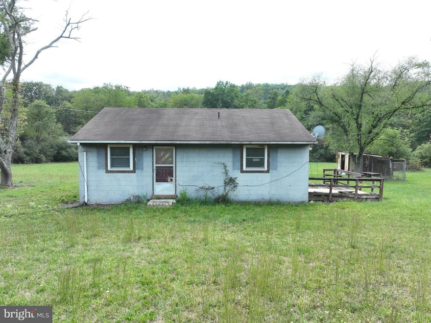 Located in the picturesque rural county of Hampshire, West Virginia, this property presents a unique opportunity for those with a vision and the skills to transform it into a wonderful home. Situated on a generous 1.96-acre lot, this solid block home is looking for a new lease on life.  With some materials already on-site, you'll have a head start on your renovation project. Whether you're an experienced DIY enthusiast or a seasoned contractor, this property promises ample opportunities for creative and structural improvements.  Lots of potential here!!  This blank canvas allows you to customize the interior to your preference and the opportunity for an affordable solution for home ownership or investment.   The spacious 1.96-acre lot provides ample room for landscaping, gardening, or even potential expansion.   Surrounded by the natural beauty of Hampshire County, this property offer the tranquility of rural living while being only a short drive away from amenities and services in nearby towns.