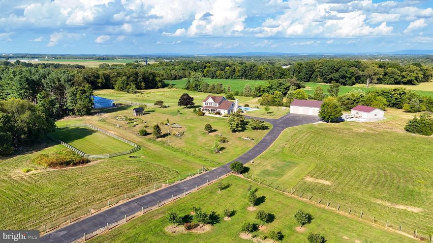 WELCOME TO RIDGEVIEW FARM... 8-STALL HORSE FARM...and so much more!  Every once in a while something this exceptional comes along.  There's something here for everyone, and it's a lot to tell you about, so here goes...situated on 28 picturesque acres in Clear Spring, MD you'll find this quality custom built all brick colonial with over 4000 finished sq ft; 4 bedrooms, 2 full and 2 half baths, gleaming 3/4" oak floors throughout; ceramic tile in bathrooms and laundry; custom cherry kitchen with granite counters and island; breakfast area with French doors to 44x12 covered patio overlooking pool; formal dining room; formal living room; office; main level laundry w/tile floor and farm sink; main level family room with wood-burning fireplace.  The upper level includes Primary Bedroom with sitting room and walk-in closet; Primary Bath w/custom tile shower, quartz double vanity, heated ceramic tile floor and window seat plus 3 additional bedrooms and bath. Walk up floored attic; 900 sq ft recreation room on lower level; 22x22 side load attached garage. and a 33x8 covered front porch.  The exterior features include 20x45 L-shaped in ground saltwater pool (new liner and generator in 2024) with pool house & half bath; 40x80 horse barn with 8 stalls, water, tack and feed rooms plus paddock and 190x65 outdoor riding arena.  35x35 detached workshop/studio with LP gas heater and woodstove.  HUGE 45x70 detached garage with grease pit, wash bay, half bath and 14' ceilings to accommodate RV's, busses, boats, large trucks, tractors, farm equipment...and more.  7x14 greenhouse for potting and garden tools. Beautiful landscaping with a variety of trees and shrubs; brick walkways in front and rear and extensive hardscape around pool; long paved driveway; fencing around driveway and fields. All buildings and property are pristine and impeccably maintained; rarely do you find this superior quality in a home. Tilt-in replacement windows; brand new architectural shingled roof in 2025.  Clear Spring Schools. DEFINITELY NOT ORDINARY!  Potential for income-producing uses such as boarding horses; renting garage bays for RV storage; lease fields for farm use and more.