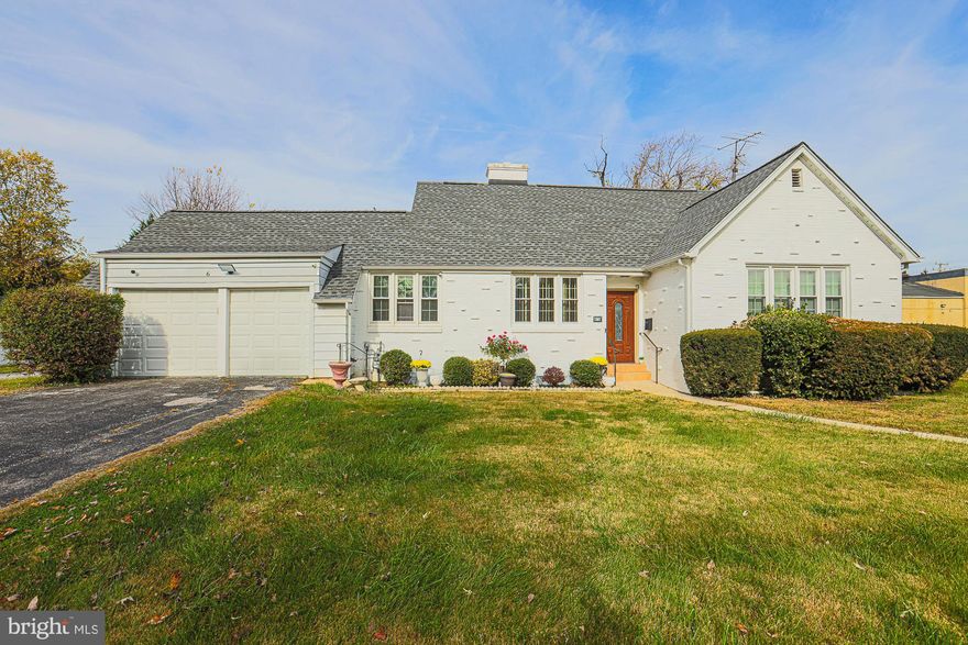 This Pikesville home offers the best of both worlds, as it is zoned for residential and business use. 
With six bedrooms, four and a half bathrooms, and a two-car garage, this white brick-front residence is move-in ready. On the main level, you will find three spacious bedrooms, two primary suites, and two and a half bathrooms.
 The kitchen is equipped with stainless steel appliances, and there is an adjacent room for a kosher kitchen or prep area. Both of these areas have easy access to storage and the garage. 

The living room features a fireplace and a formal dining room with corner cabinets- and both have wood floors, making it the perfect setting for family or guests.

Upstairs are two additional bedrooms, a full bathroom, and an expandable attic that can be used for storage or additional bedrooms. 

With outside access, the lower level features two more rooms, a bedroom, and another full bathroom. The large, level, fenced yard with a patio and plenty of paved parking in front, side, and back is perfect for outdoor activities.
This property offers rare business potential, as it is conveniently located across from the Suburban Country Club and within walking distance to nearby shops, restaurants, and transportation. 

Here is your opportunity to own a move-in-ready home perfect for personal and business use. With 6 Clarendon Ave, you can have the best of both worlds – a home business or a business home.