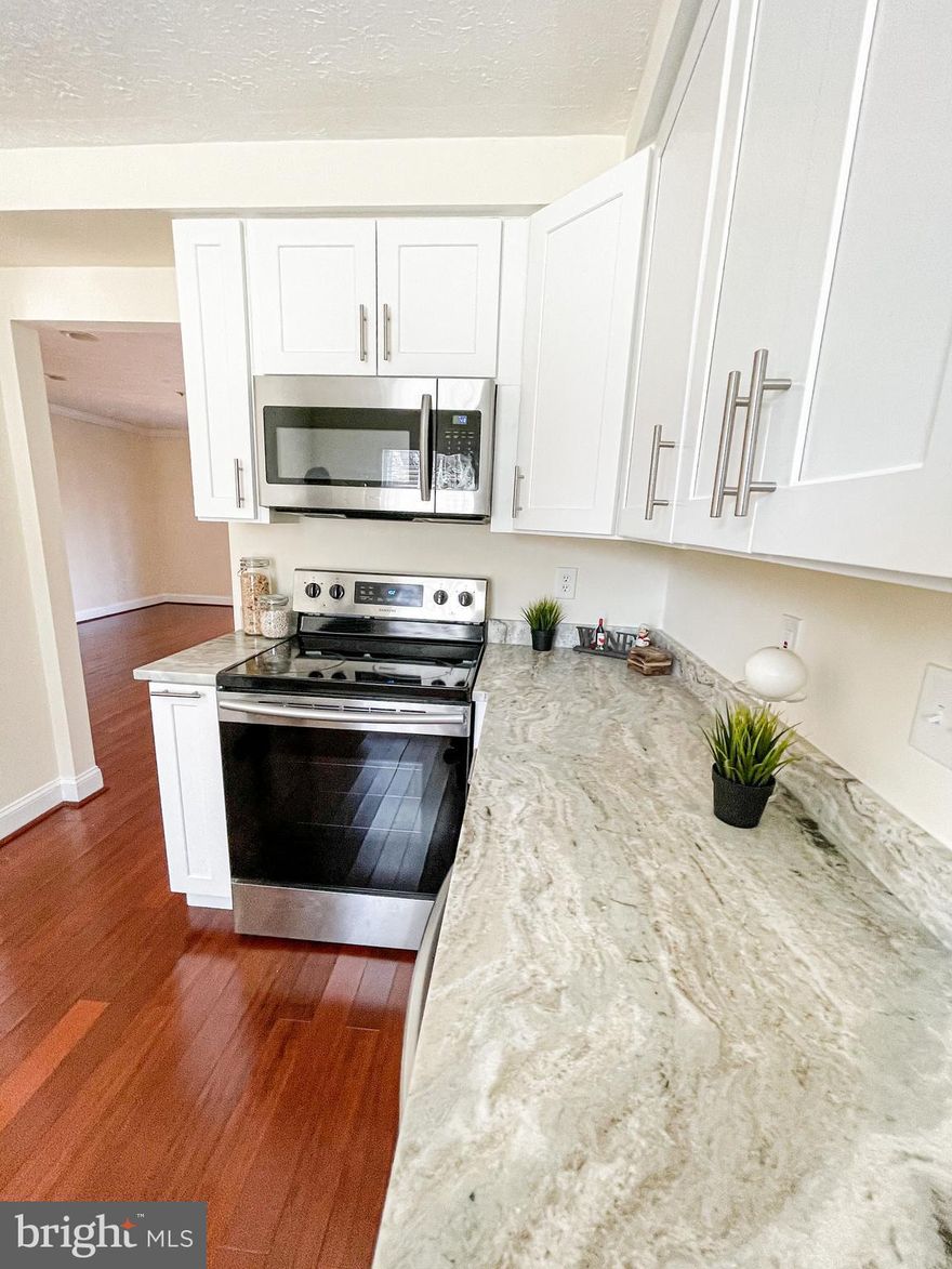 LOCATION!! LOCATION!! 3 level end of unit Town House with very spacious 3 bedrooms and 2 full bathrooms, One year old roof and hardwood floors on main level. Fully carpeted on top floor. One year old appliances,  updated kitchen with stein steel appliances and granite countertops. New windows, fully finished basement with lots of storage spaces. New Deck.