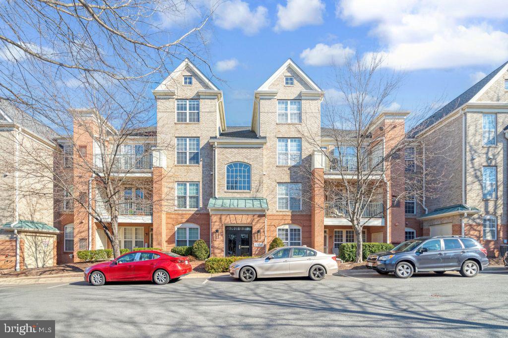 Located in the heart of Reston Towne Center is this beautiful 1344 sq ft., 2-story, PENTHOUSE condo. This unit has 3 bedrooms (2 downstairs and 1 upstairs), 2 full baths, 2-stories with vaulted ceilings. It's freshly painted in neutral two-tone Sherwin Williams paint and boasts NEW high quality Shaw wool carpeting & NEW LTV flooring in the kitchen & laundry room. The kitchen has ALL NEW Frigidaire appliances: side-by-side refrigerator with ice dispenser/water, Electric Range with an induction cooktop and built-in AIR Fryer, a quiet dishwasher & microwave. The kitchen has Corian counter tops. There are new 2" faux wood blinds. The gas fireplace in the living room has remote starter & marble trim. The master bedroom has a walk-in closet. The laundry room has a NEW GE dryer and nearly new GE washing machine. As far as major appliances, the unit boasts a new furnace, A/C and water heater. There's a balcony off the Great Room. A 1-car enclosed garage plus 1 additional parking space. Amenities include a community pool, clubhouse and exercise room. It's is located across from the Reston Towne Center in the prestigious West Market development. Walk to the hospital. The hiking trail is nearby. Please note there is no elevator . There are two flights of stairs leading to the condo.