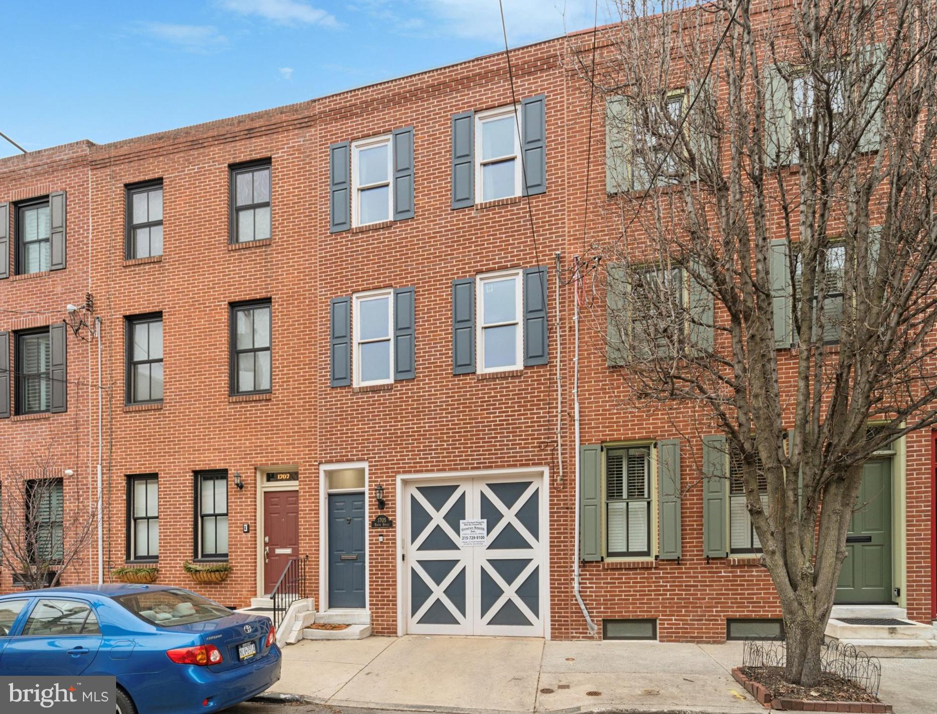 Beautifully renovated home located on a peaceful, tree-lined block in the vibrant Spring Garden section of the Art Museum Area. This stunning three-story property has been thoughtfully updated with luxurious finishes and modern amenities throughout, offering a truly move-in ready experience. Every floor, room, and corner has been touched by a recent remodel, leaving no detail overlooked. Upon entering, you’re welcomed by an open, light-filled space anchored by a chef’s kitchen featuring a premium La Cornue range, sleek cabinetry, a panel-front refrigerator, Carrara marble countertops, and a 70+ bottle wine fridge. Modern open shelving pairs with a hidden pantry for extra storage, while the custom butcher block island offers seating for 8+ with its leaves, perfect for entertaining. Oversized windows and double glass doors allow natural light to flood the space and lead to a landscaped rear brick patio, ideal for outdoor dining and gatherings. A convenient powder room and storage closet complete the first floor.
Upstairs, the second floor boasts an extended living area with a cozy gas fireplace and access to a rear deck that overlooks the lush patio and garden below. The spacious front bedroom features two large windows, double closets, and jack-and-jill access to a beautifully appointed full bath with a herringbone marble wall, soaking tub, and seamless glass shower. The third floor is bright and airy thanks to a large skylight. The primary suite includes a wall of built-in closets with his-and-her sections, along with an elegant en-suite bath featuring a rainfall showerhead, double-sink wood and marble vanity, and sophisticated tile work. A conveniently located laundry room with full-size stackable washer and dryer is also on this floor, along with a third bedroom offering ample closet space, large windows, and an additional full bath.
The finished basement provides extra living space and storage, while the one-car garage includes an electric car charging station for added convenience. Enjoy all that the Art Museum Area has to offer, including close proximity to the Philadelphia Museum of Art, Fairmount Park, the Rodin Museum, and a full city-block community garden just around the corner. This location also provides easy access to Center City, public transportation, and some of the city’s best restaurants, cafes, and boutique shops. This home is a must-see for anyone seeking luxurious living with the best of Philadelphia at their doorstep!