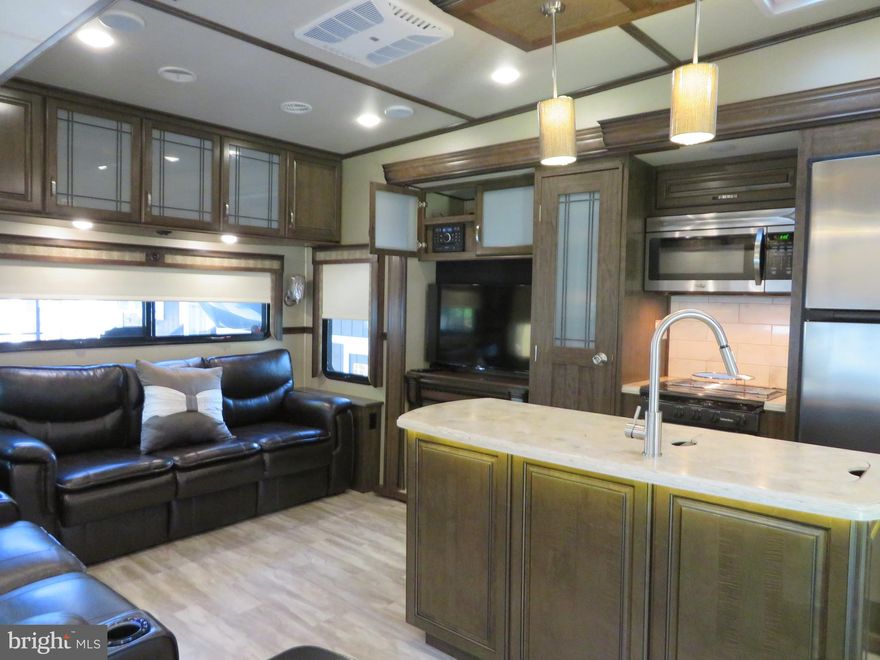 Schedule your showing today to see this well maintained 2017 Grand Devine Solitude 5th Wheeler on a nice, level, corner lot at the entrance to Riverbend RV park. Lot also has gravel area for parking, firepit and shed (golf cart does NOT convey). The RV's living/dining area features include a  couch w/a queen size pull out bed, loveseat w/recliners that have heat and massage, TV, stereo system/DVD/Bluetooth, fireplace, table w/2 benches, pantry, full size refrigerator/freezer, full size under the cabinet microwave, stove, island w/under counter lights, plenty of cabinets/storage, counter space and drawers. The bathroom has a single sink, toilet, medicine cabinet and a large shower with seat. The primary bedroom has a king size bed with storage, large closet, closet for washer/dryer (not included), TV and dresser. The secondary bedroom has a full size pull out couch, storage/clothes cabinet & shelf for a TV (not included). Additionally, there is a large loft/bunk area w/TV hook up. Riverbend RV Park has private Potomac River access for boating, fishing & swimming. Riverbend RV Park's yearly membership includes water, sewer, electric, trash and the park amenities such as pools, putt putt, basketball court, tennis court, holiday fireworks for July 4th, car show, carnival, restaurant, playground, ball field and much more. Riverbend RV Park is located close to shopping, I81 & The C&O Canal for hiking & biking. Own this getaway in as little as 3 weeks. Call today before it's gone! **Gated community-pass required for entry. **Riverbend sales are SOLD "AS IS", CASH only and seasonal.** (Direct TV and Frontier Internet available with service install/hookup).