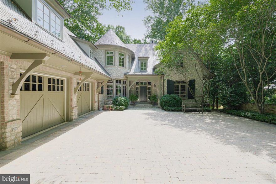 This European craftsman-style luxury home in Merry-Go-Round Farm offers exceptional quality and attention to detail. Designed by architect Jim Rill, every architectural detail was carefully crafted for this 6900+ square foot house. The combination of French farmhouse and American influences creates a unique and elegant ambiance. The stone exterior, slate roof, copper gutters, and rustic stonework blend harmoniously with the wooded surroundings and panoramic views of the Potomac River. Inside, the emphasis on clean lines, simple ornamentation, and the extensive use of quarter-sawn oak trim and paneling add warmth and beauty throughout the home. From the dining room with its heated limestone flooring and honed marble fireplace to the living room each room exudes exceptional craftsmanship. The family room features a stunning stone fireplace, wood beamed ceiling, and French doors opening to a balcony overlooking the Potomac. The craftsman-inspired Jennifer Gilmore kitchen is a masterpiece with exquisite wood quarter-sawn oak paneling and cabinetry, granite countertops, and a circular breakfast area offering picturesque views of the woodsy backyard and the Potomac River.
The upper level boasts a luxurious primary suite with a wall of curved windows capturing the extraordinary view. The primary bathroom was recently renovated with Dekton countertops, heated towel warmer and floors. Adjacent to the master suite is a magnificent study or sitting room with built-in bookshelves, a fireplace, and windows overlooking the Potomac. Two additional en-suite bedrooms round off the upper level. The walkout lower level is perfect for entertaining with a second family room featuring travertine heated flooring, a fireplace, and French doors opening to a flagstone patio with stone arches. Two bedrooms with ensuite bathrooms, an exercise room, wine storage area, and ample storage space complete the lower level. Home has gas generator so you will never be without electricity.  Merry-Go-Round Farm is a highly sought-after neighborhood offering shared amenities, including walking trails, tennis & basketball court and an equine facility with boarding facilities. The HOA fee includes lawn care, ensuring a low-maintenance lifestyle for residents. Nestled at the end of a quiet cul-de-sac and located in the Churchill school cluster, this extraordinary property presents a rare opportunity to live in a meticulously designed home with breathtaking views of the Potomac River in a prestigious and exclusive neighborhood.