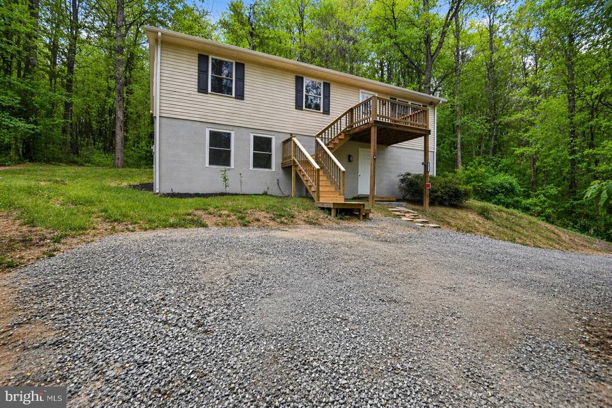 Fully updated and move-in ready, this 2005-built home offers a bright, open layout with vaulted ceilings and modern finishes throughout. The kitchen has been completely renovated with white shaker cabinets, stainless steel appliances, updated countertops, and a center island for added workspace and seating.

All flooring has been replaced with high-end luxury vinyl plank, and the entire home has been freshly painted for a clean, cohesive look. Bathrooms have been refreshed with updated fixtures and finishes, providing a low-maintenance, turnkey feel.

Outside, a newly installed driveway offers ample parking, and the rear deck provides functional outdoor space. Set on a wooded lot, this home offers privacy and usability with no immediate work required.