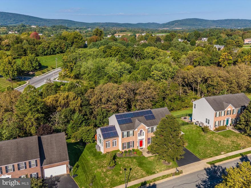 Enjoy stunning picturesque sunset views of South Mountain from your back yard everyday!  Located steps to the heart of Middletown and Wiles Branch Park, this exquisite brick colonial is perfectly located to enjoy small town living at its finest. Over 3,700 square feet of luxurious living space. Featuring 4 bedrooms, 3.5 baths, and a walkout basement with full light windows, it’s a dream home. The gourmet kitchen, with morning room, oversized island, granite countertops, and 42-inch cabinets, is a chef’s delight. Wonderful tiered decks and beautiful paver patio out back. Wider lot also allows for beautiful Solarium side addition. The home also features 9 ft ceilings, a gas fireplace in the large family room, wood staircase, a first-floor office, and an elegant primary bedroom with two walk-in closets, sitting area and luxury bath with sitting room. Custom window treatments and abundant natural light add to the charm. Plenty of storage as well.  No detail was missed.  With upgrades throughout and a spacious layout, this Courtland model is truly a gem. Sought after Middletown Schools as well.  PLUS NO HOA!  Perfect 10! **Please note there is also a 4 N Pointe CIRCLE, this property is 4 N Pointe TERRACE**
