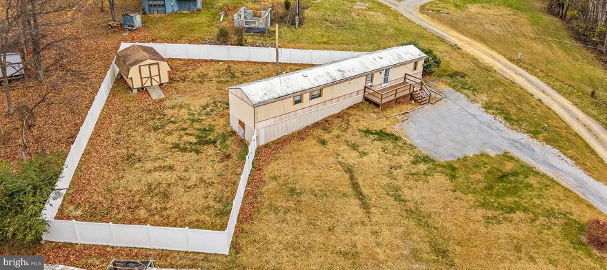 Welcome to 87 Explorer Ln!  Looking for affordability and some privacy? This charming property offers .62 acres of land—NO lot rent! You’ll OWN the land and the home.  Highlights You’ll Love:  6-ft vinyl privacy fence (only a few years old!), large front deck perfect for relaxing or entertaining. Private well & septic, no monthly water or sewer bills. The metal roof was painted a few years ago for long-lasting durability. Nice storage shed with electricity, great for tools, hobbies, or extra storage.   All appliances are included, including washer and dryer.  The home features a separate dining area with a built-in desk, perfect for work, school, or additional organization. Primary Suite is a spacious bedroom with two large closets and a private bathroom featuring a soaking tub and separate shower.  Close to town for shopping and conveniences, yet tucked away enough to enjoy the peace and privacy you desire. Important note: this home is not on a permanent foundation. Buyers should check with their lender regarding financing options for manufactured homes without permanent foundations.  Own this property with land for UNDER $150K! Opportunities like this are rare, don’t miss your chance!.