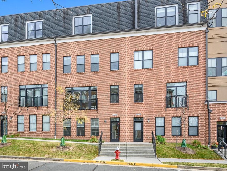 Welcome to 19290 Winmeade Dr, a modern light-filled 2 car garage townhome style condo in the heart of Lansdowne Towne Center.  Come spread out in this beautiful 3 bedroom, 2 full and 1 half bathroom property with beautiful engineered wood flooring on all 3 levels.  Modern black window frames set off nicely against freshly painted SW Alabaster walls.  The ground level is an open flex space that can be used as formal living, an office, a workout room etc.  On the main level you will find a great room concept with open family room/kitchen/dining room.  This gourmet kitchen comes with stainless steel Kitchen Aid appliances, quarts counters and ample storage.  The bedroom level hosts the primary suite, 2 secondary bedrooms, a hall bath and the laundry closet with a full sized stacked front loading washer and dryer set. Playing the long game, this home comes with an elevator shaft and is pre-wired ready for the elevator of your choice.  Walk to shopping/dining.  The community comes with a pool, fitness center, dog park, trails, tot lot and so much more! This address feeds to great Loudoun County Public Schools.  Easy access to main roads.